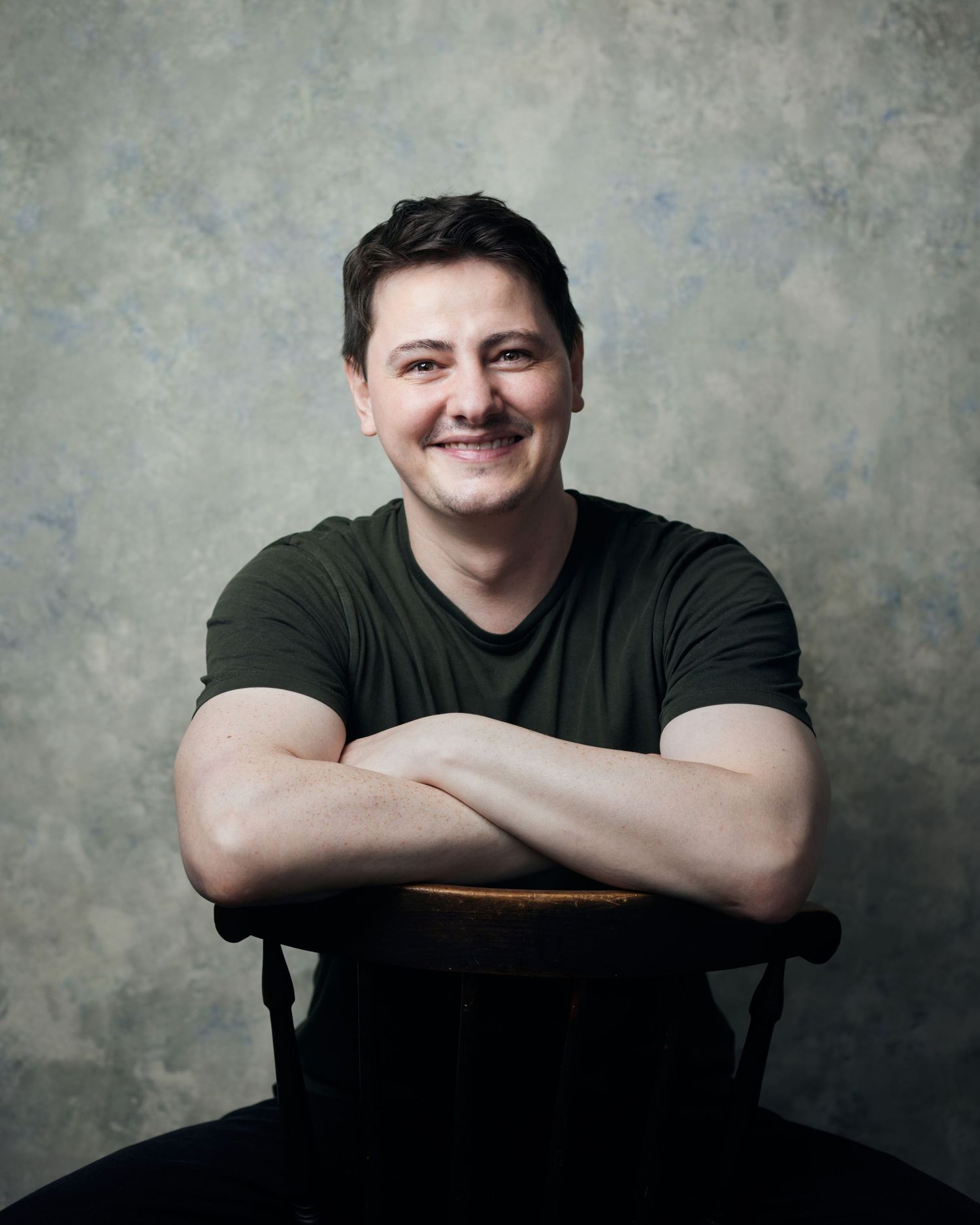 Heartfelt smiley headshot; actor with a warm, authentic, and happy smile.