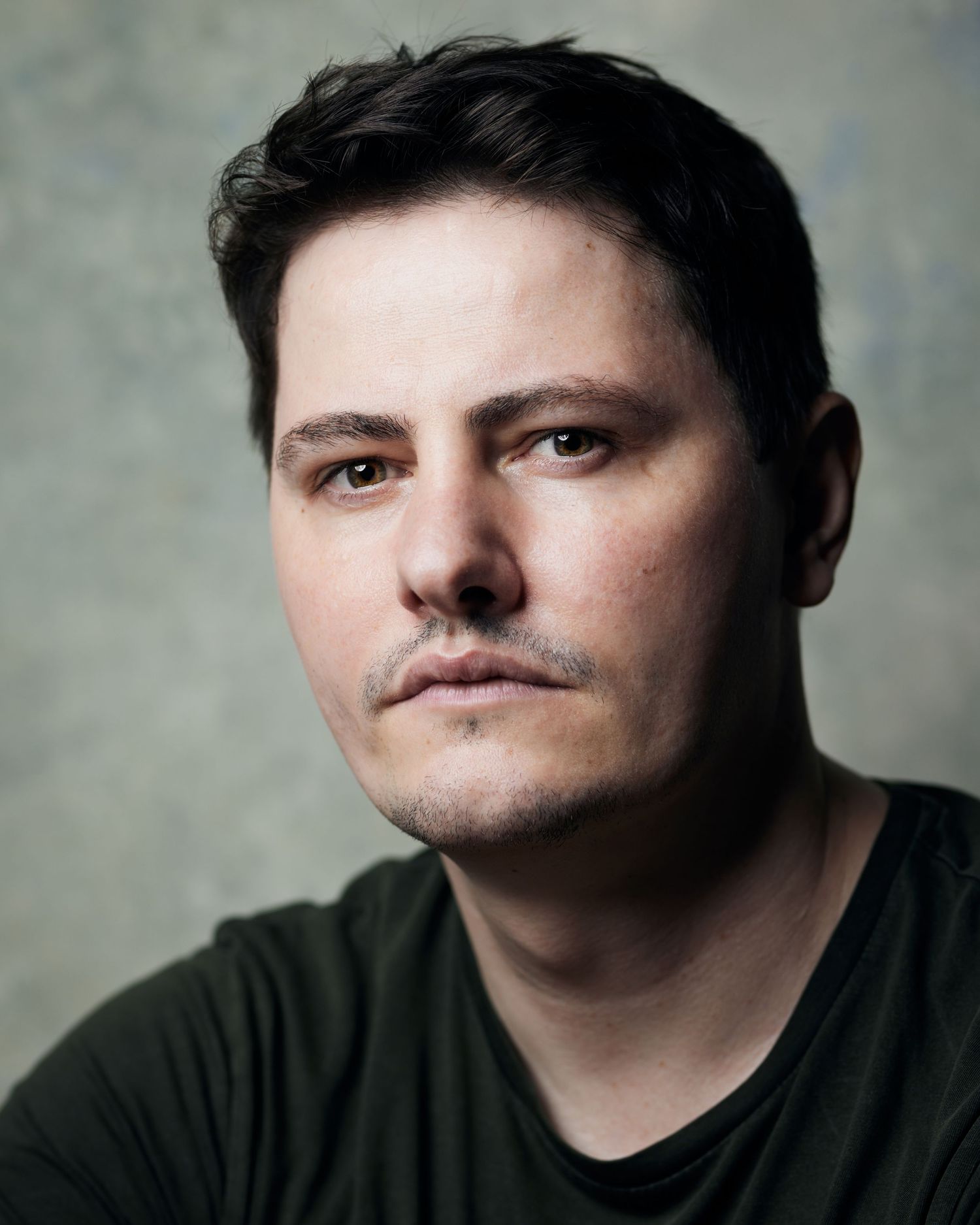 Striking character headshot; man with a cold, direct stare for ambitious roles.