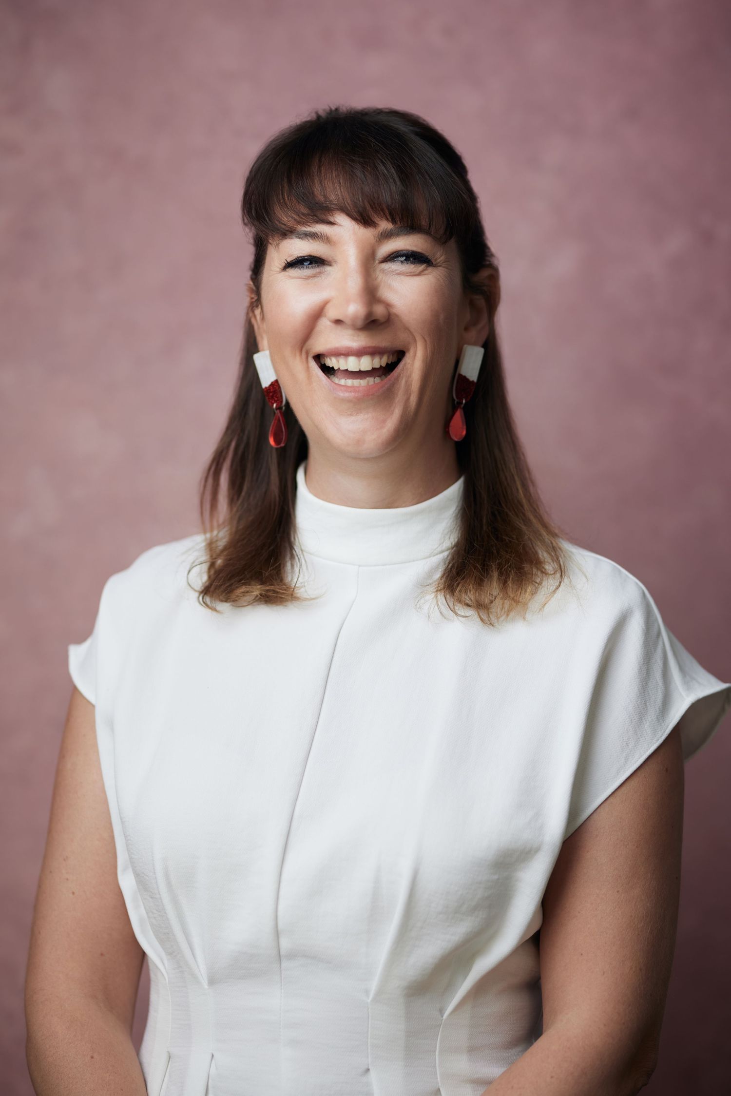 Happy professional headshot; woman with a radiant smile by Cardiff photographer Geraint Todd.