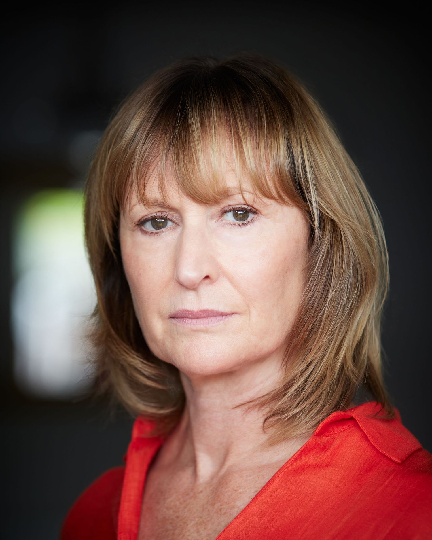 Professional headshot of actress Sharon Roberts, black top, soft smile, natural lighting.