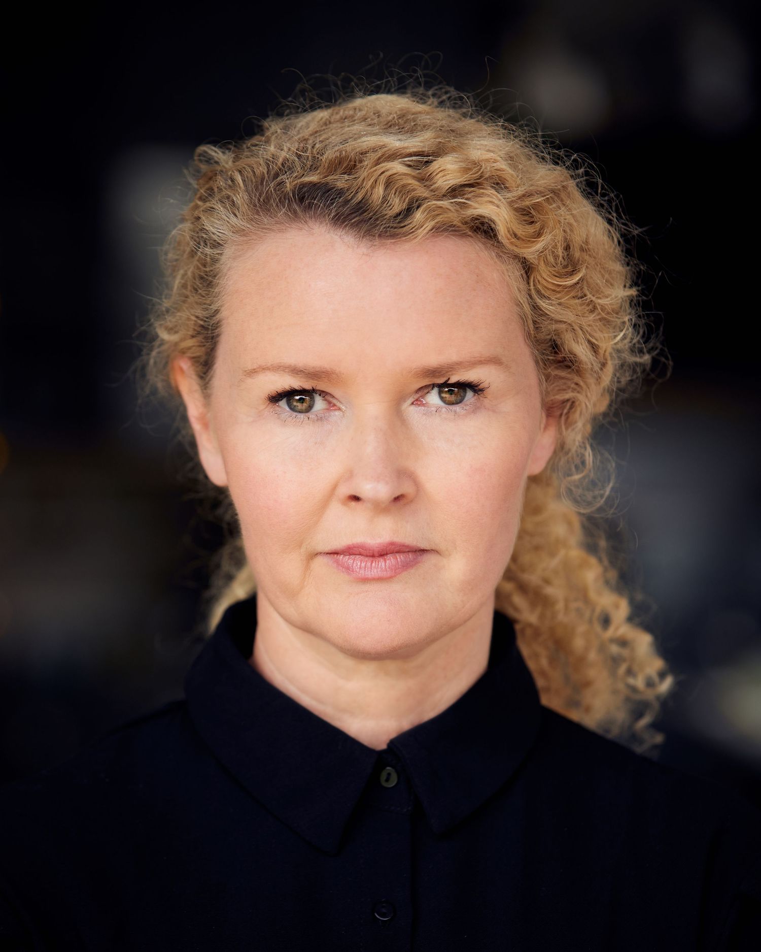 Sophisticated actor headshot; timeless presence in Cardiff natural daylight.