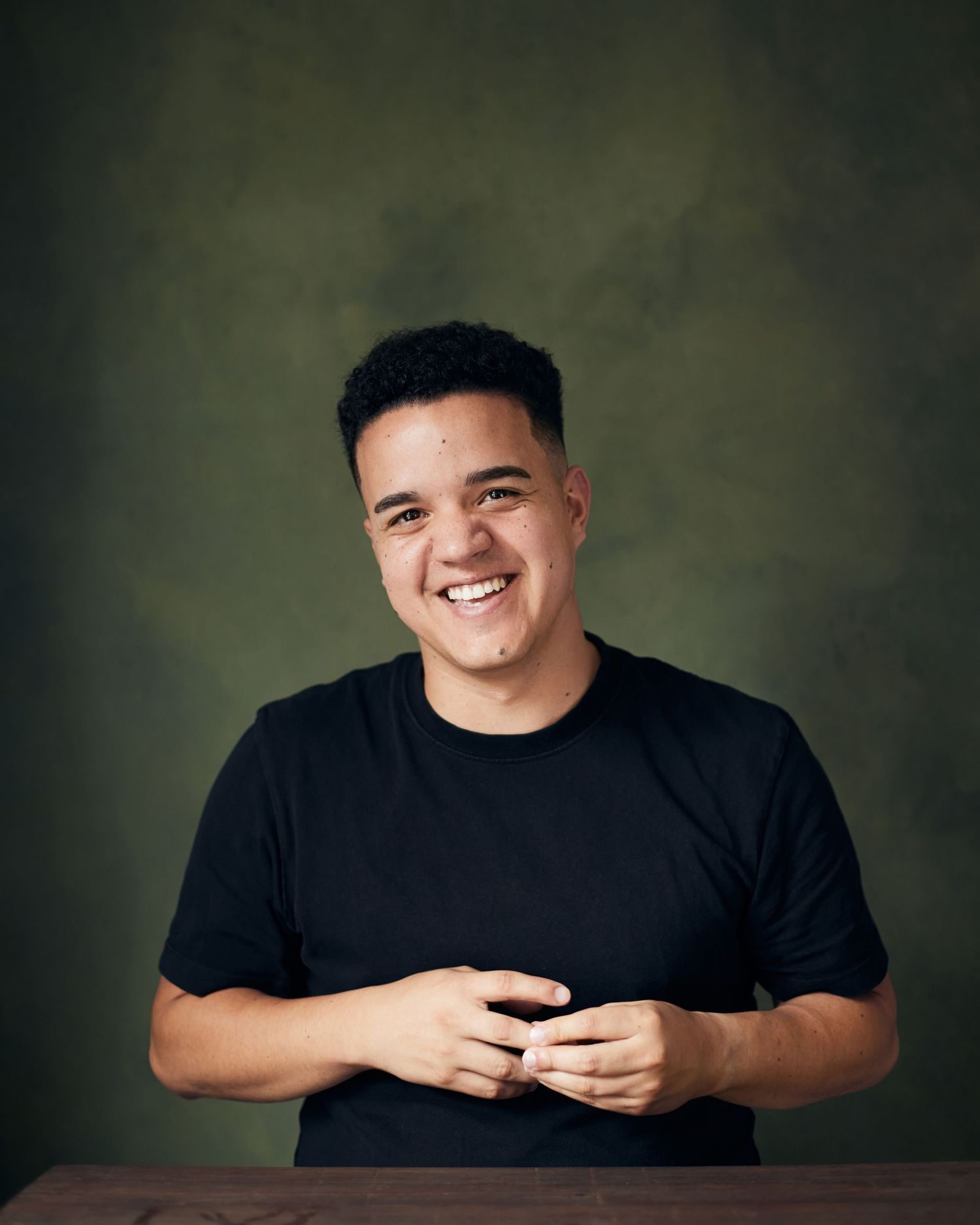 Infectious smile headshot; male performer with a happy and energetic presence.