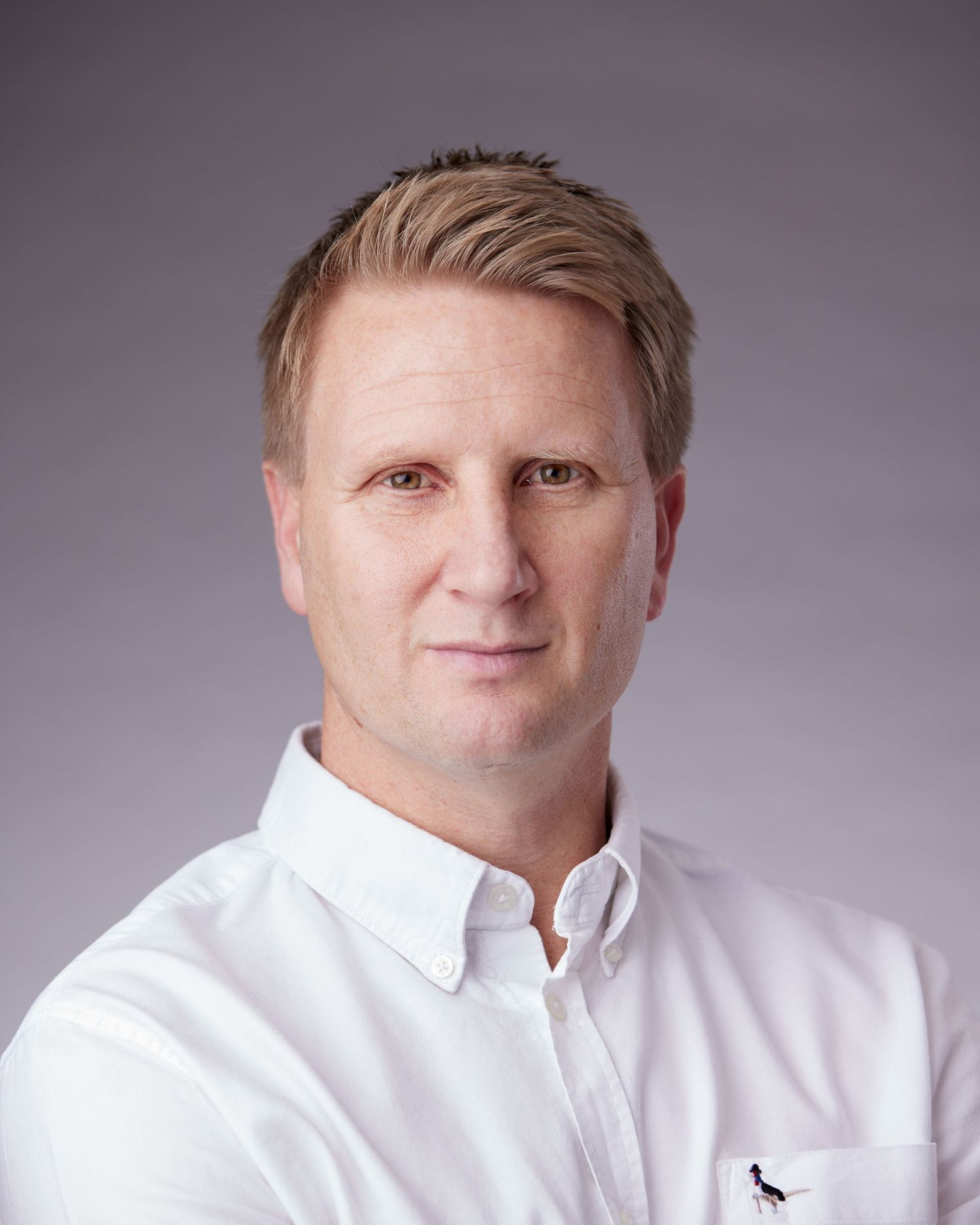 Powerful corporate portrait; businessman with a strong, commanding presence in a Cardiff studio.