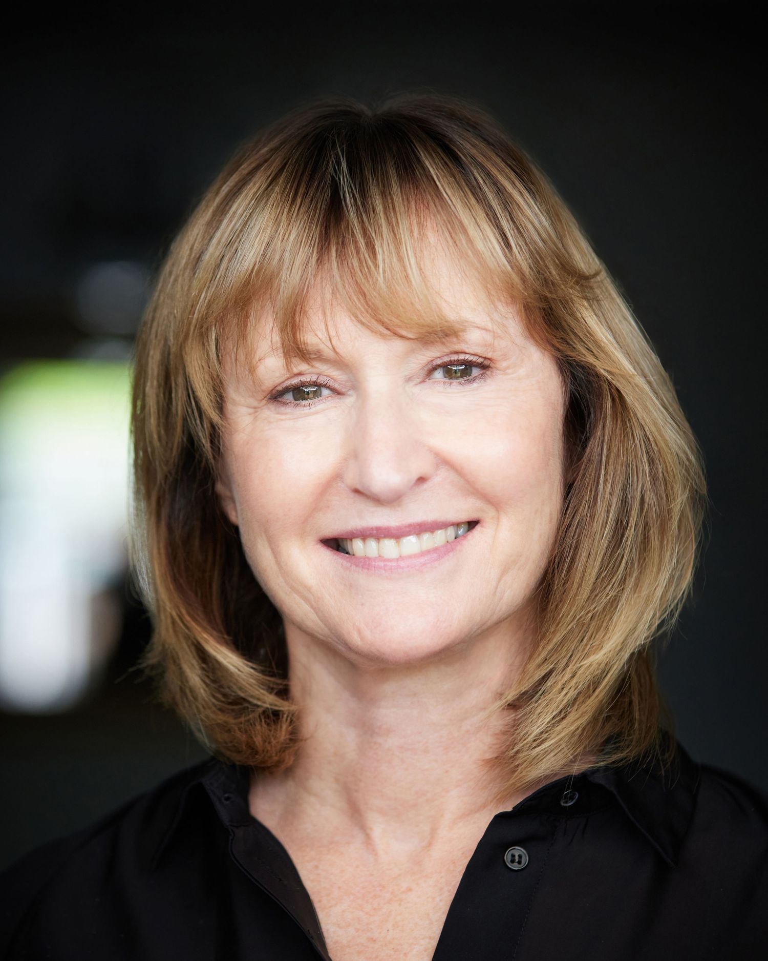 Sharon Roberts actor headshot Cardiff, focused dramatic expression, black shirt.