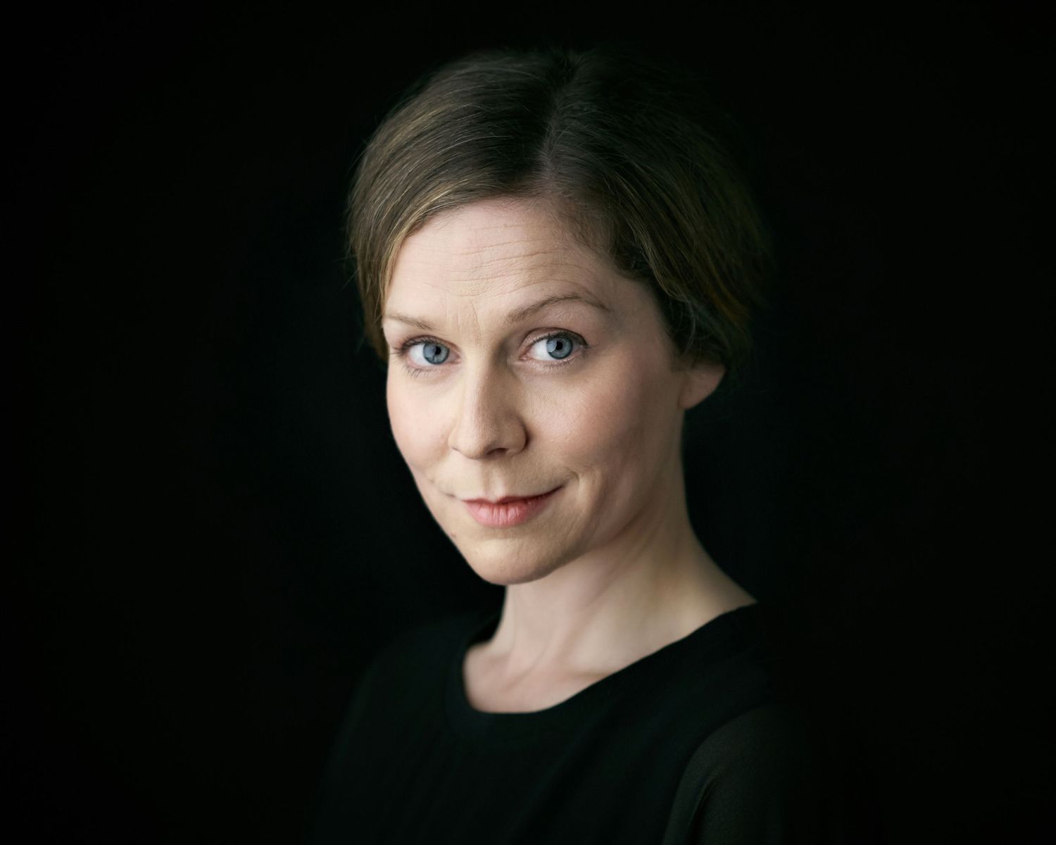 Intense female performer headshot showing a strong character range.