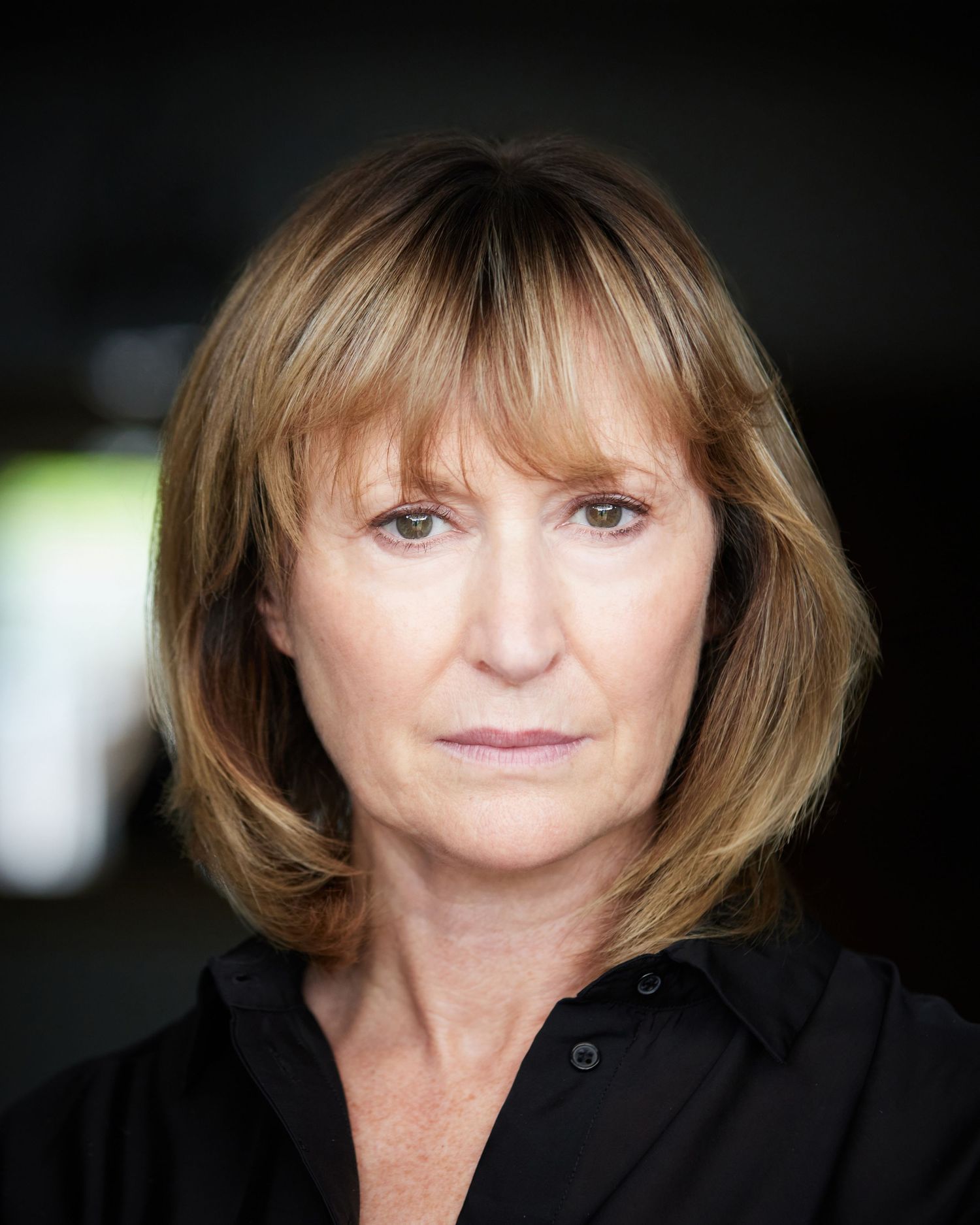 Sharon Roberts acting headshot, warm smile, approachable character look.