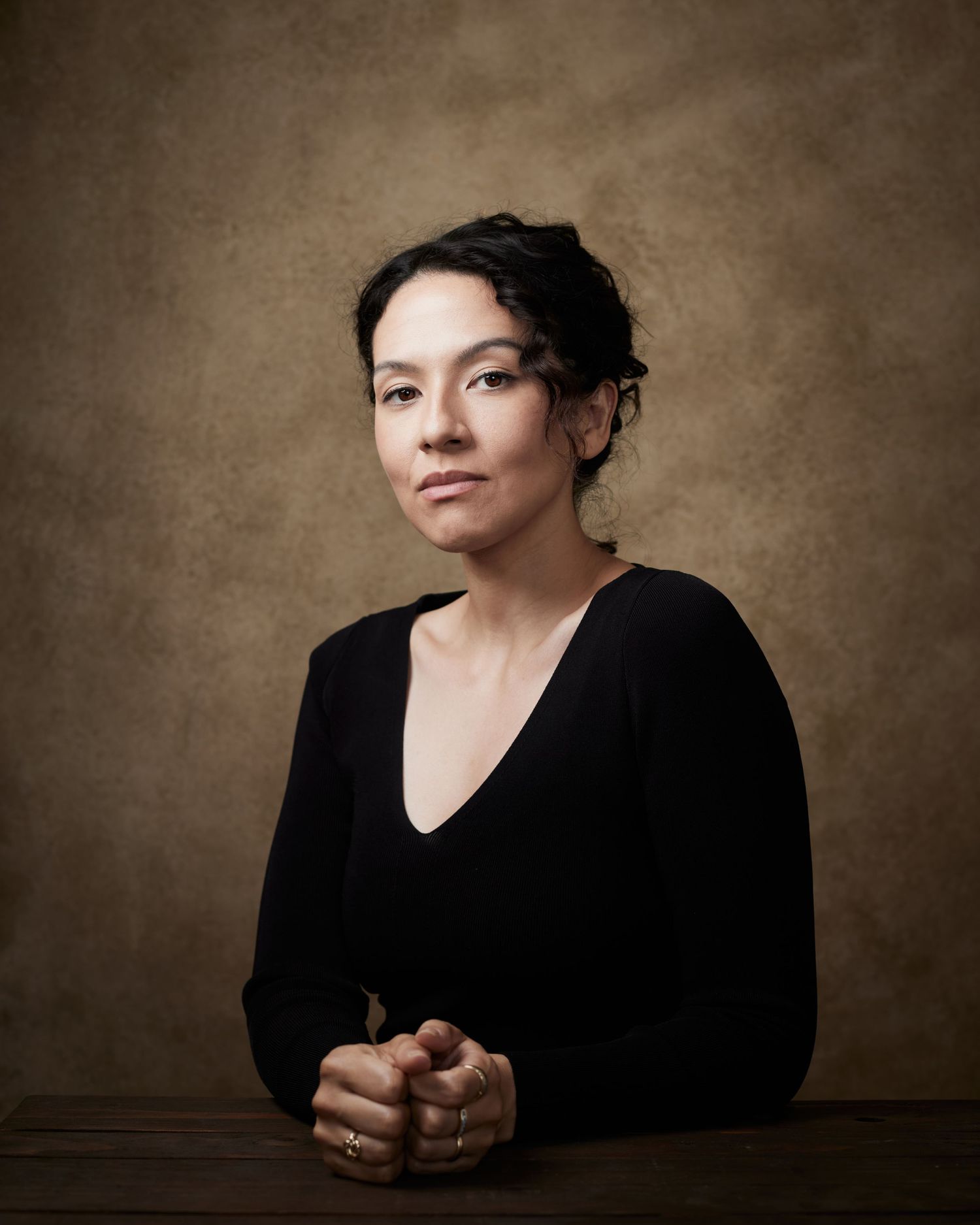 Professional timeless headshot; woman with a serene, confident look.