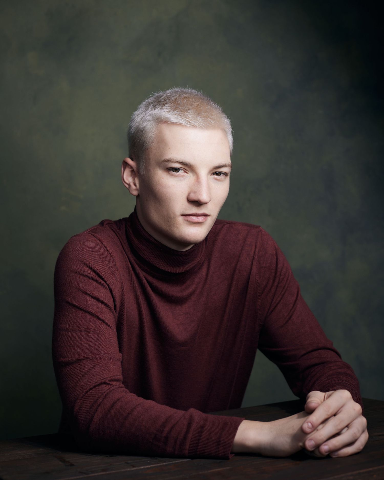 Sharp-edged portrait; actor with a piercing, intellectual gaze and crisp lighting.