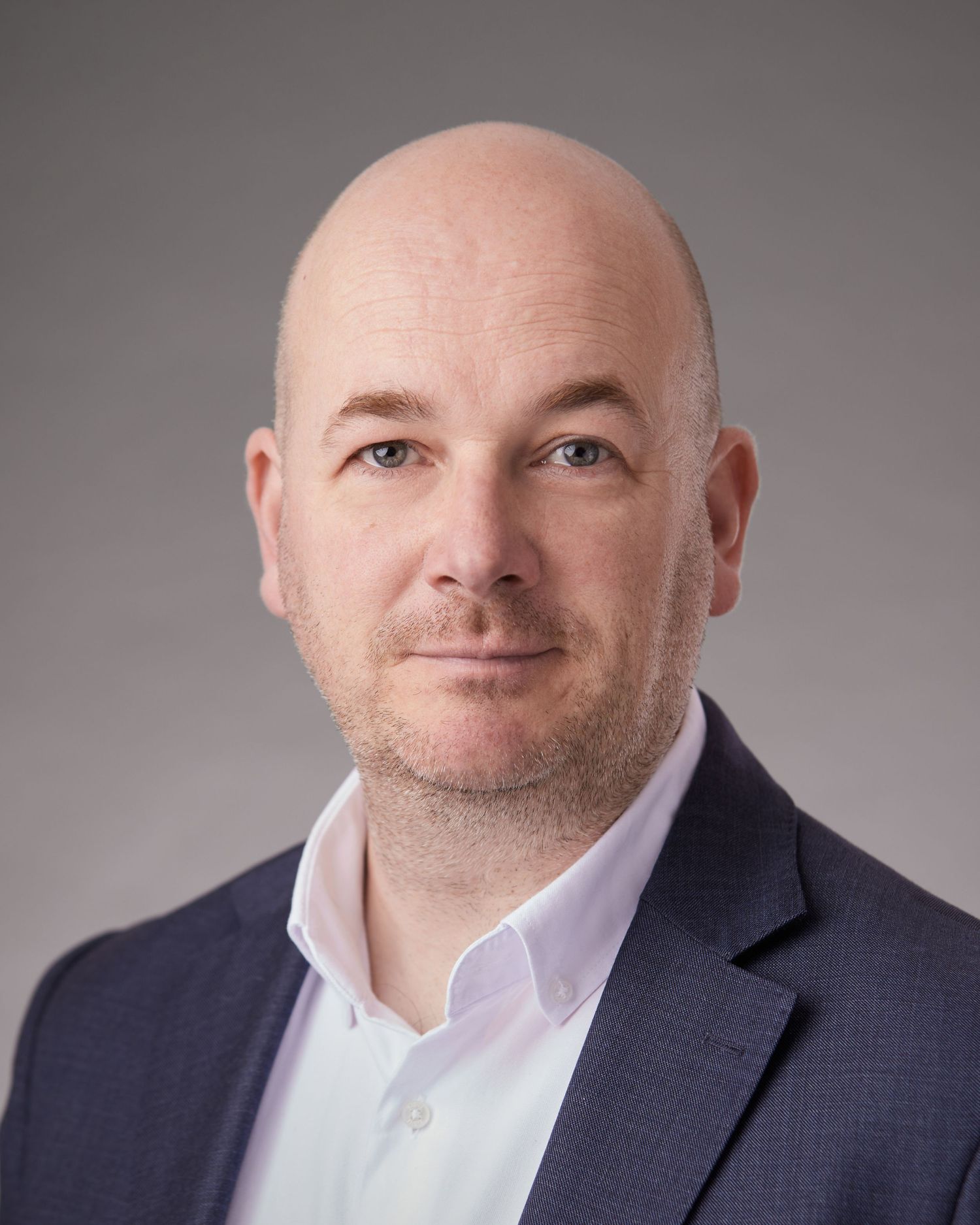 Formal corporate portrait of a Cardiff solicitor in a suit.