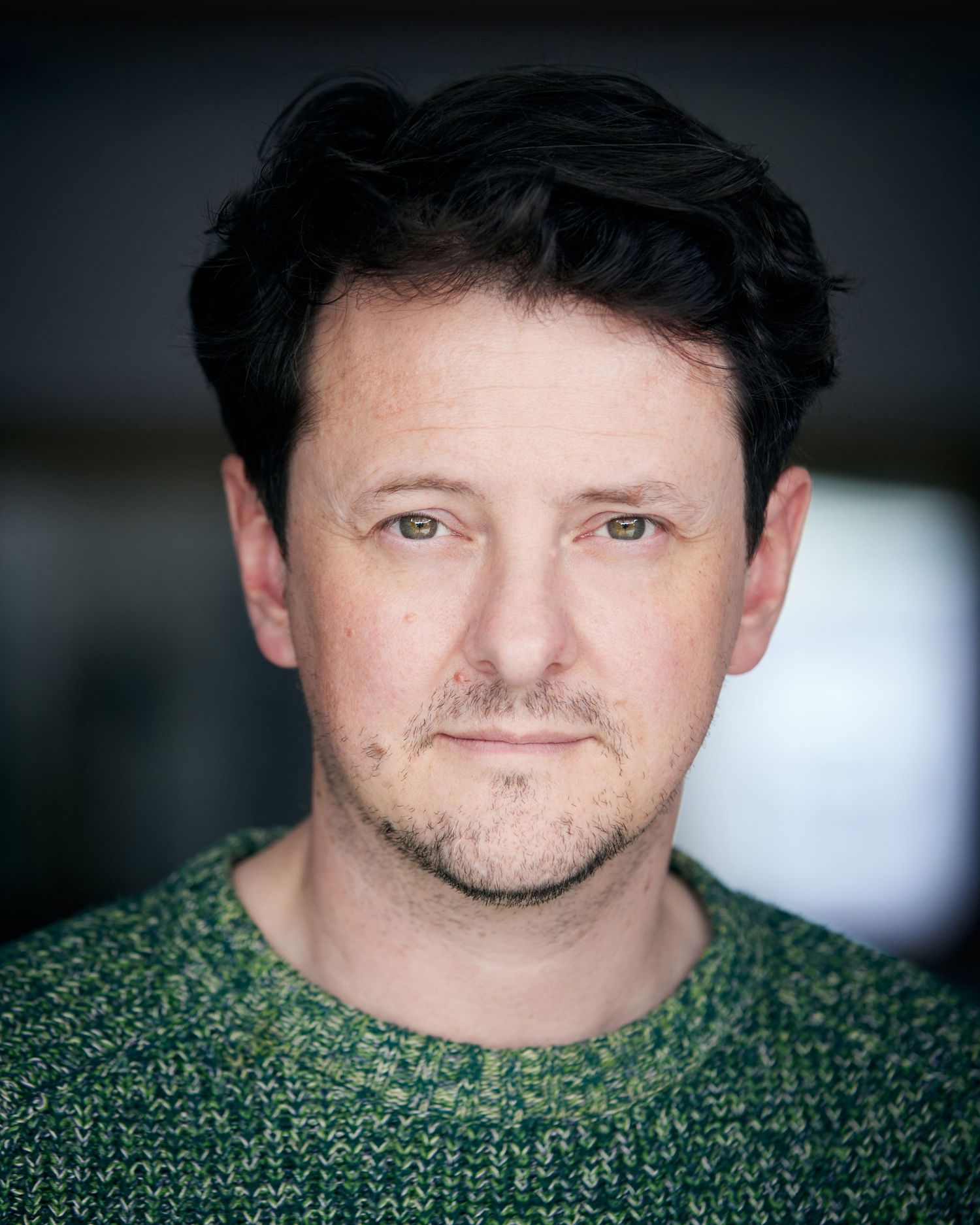 Warm approachable headshot; friendly look with a subtle Cardiff smile.
