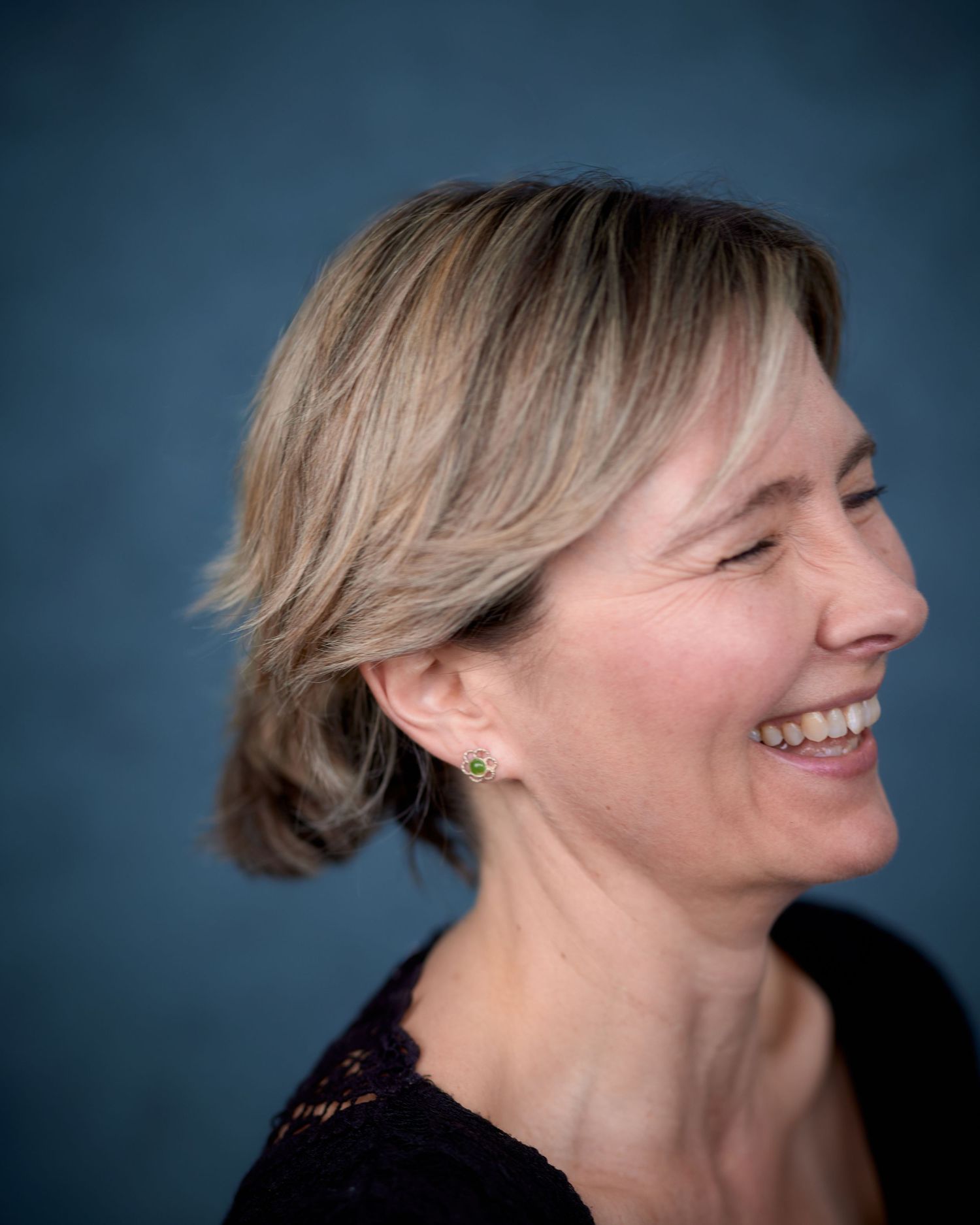 Profile shot of actress Noni Lewis laughing during a Cardiff headshot session. Natural, high-energy actor personality photo.