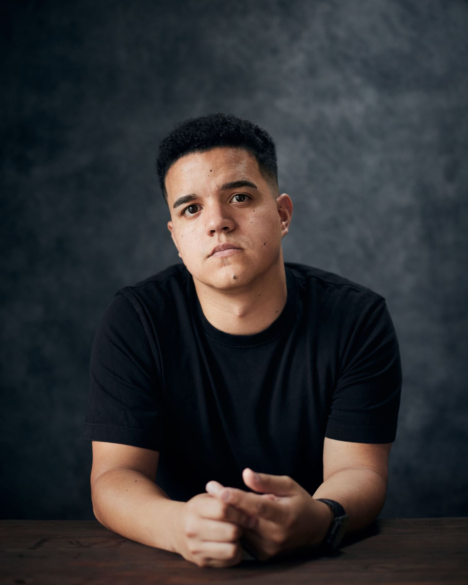 Bold character headshot; actor with a defiant, resilient expression in the studio.