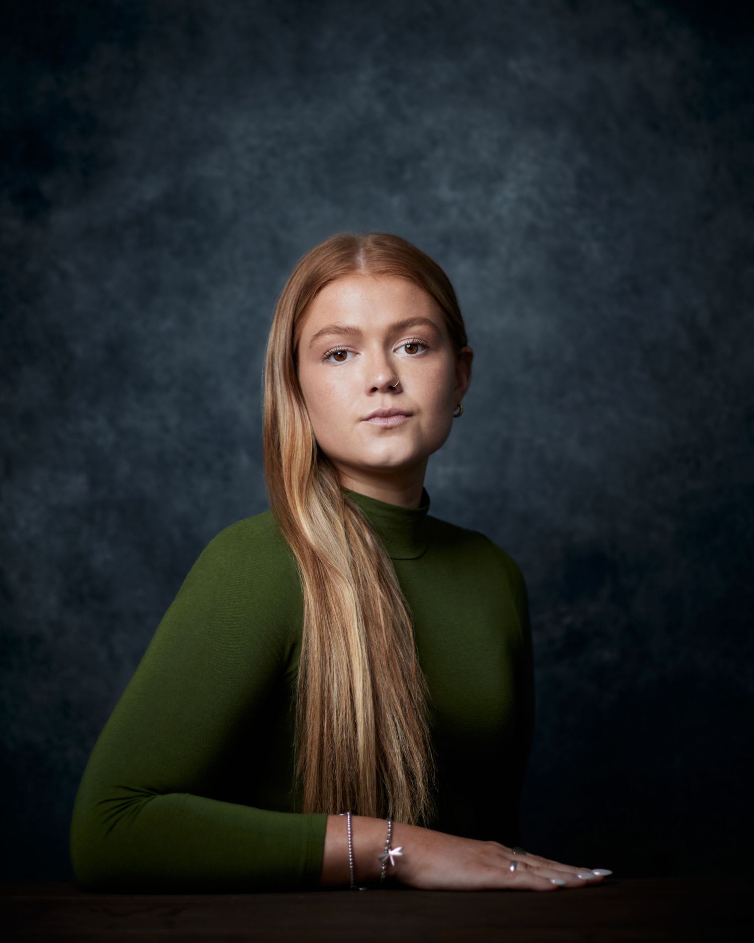 Formal studio portrait; actress with a classical, high-society character look.
