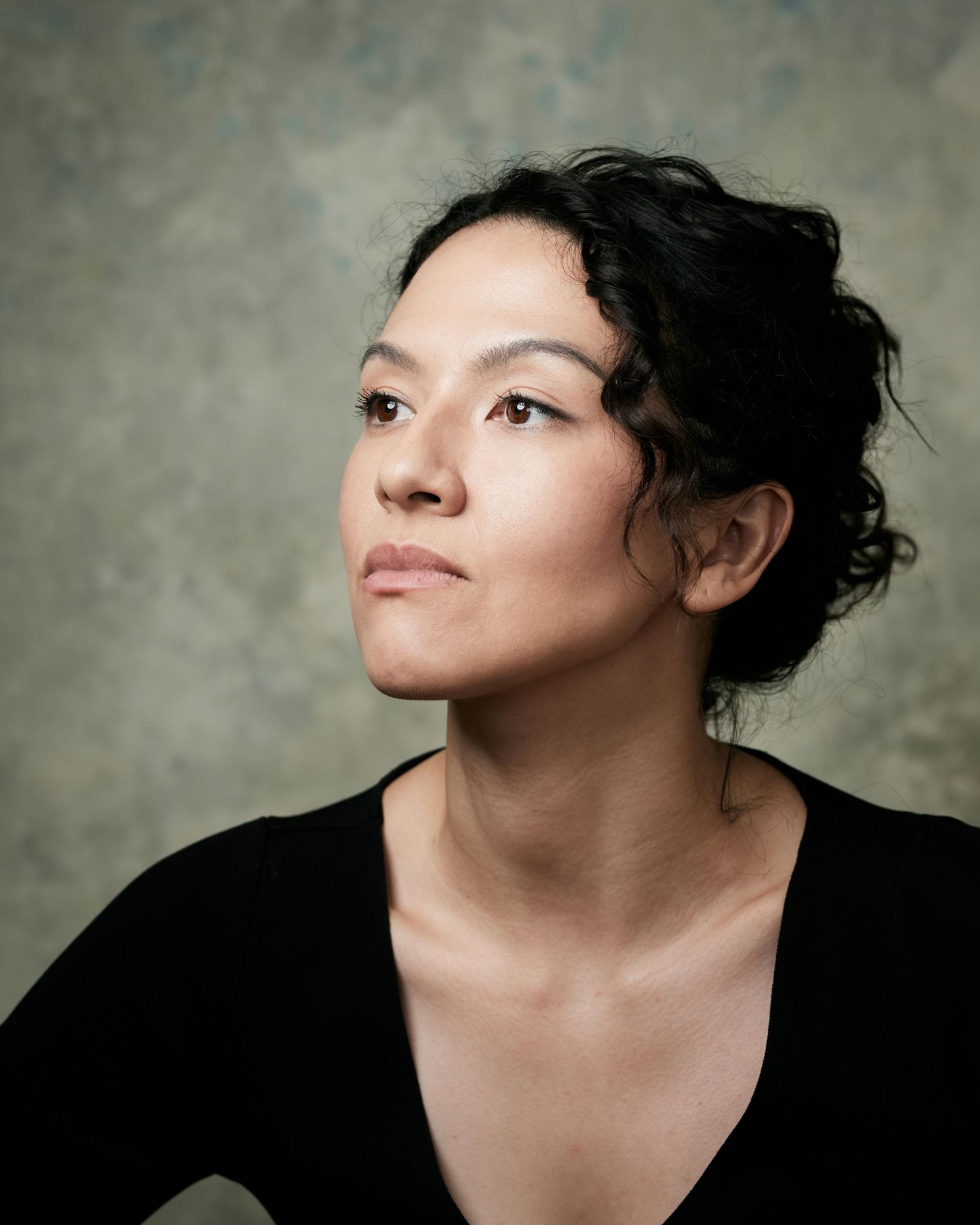 Soulful classic headshot; woman with a strong, contemplative period gaze, looking off-camera.