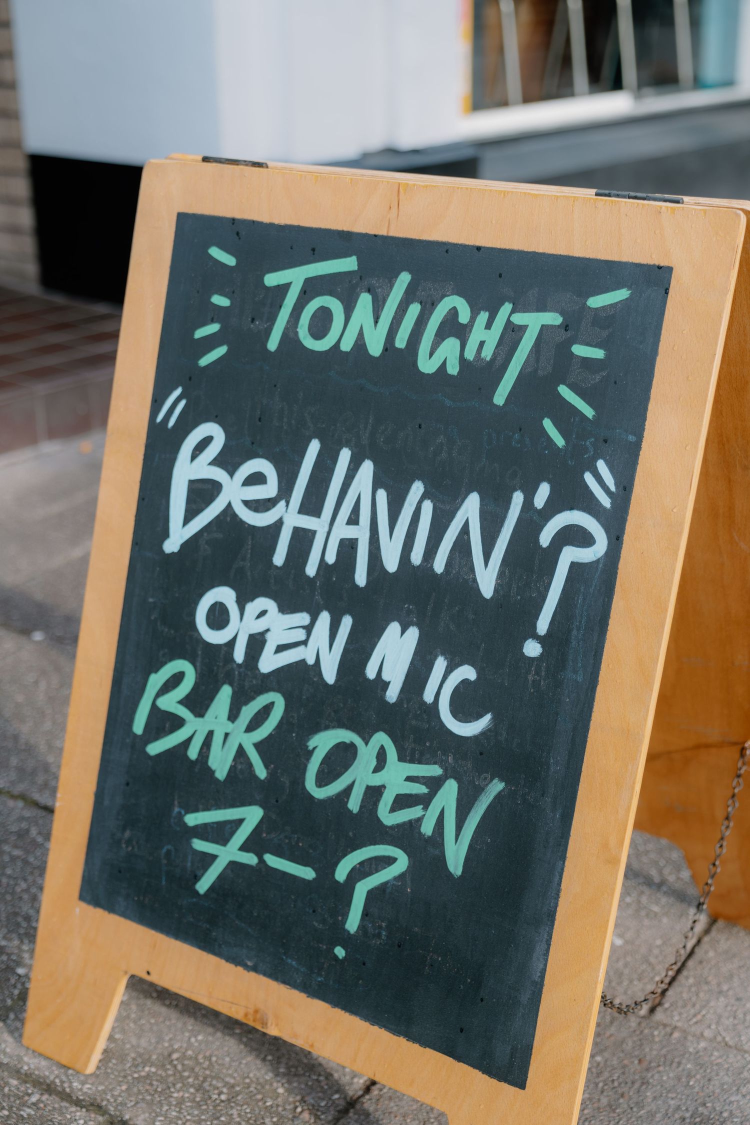Chalkboard sign outside a venue advertising tonight's 