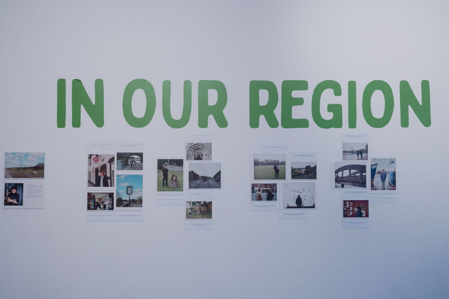 Gallery wall display titled 'In Our Region' in green text with a collage of small photographs arranged below.