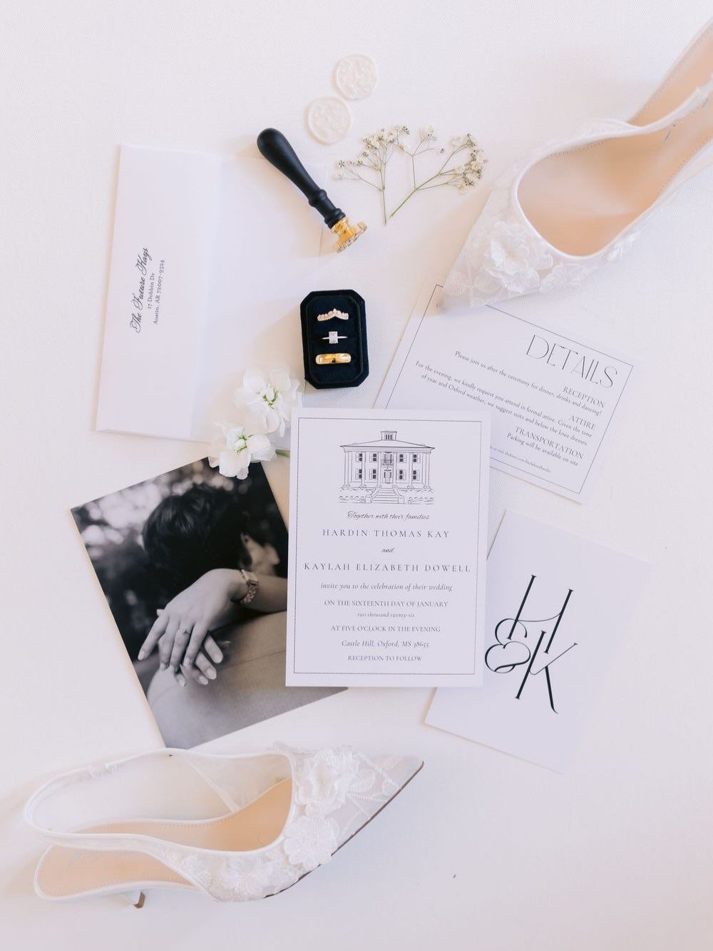 Wedding details including invitations, rings, and shoes arranged on white background.