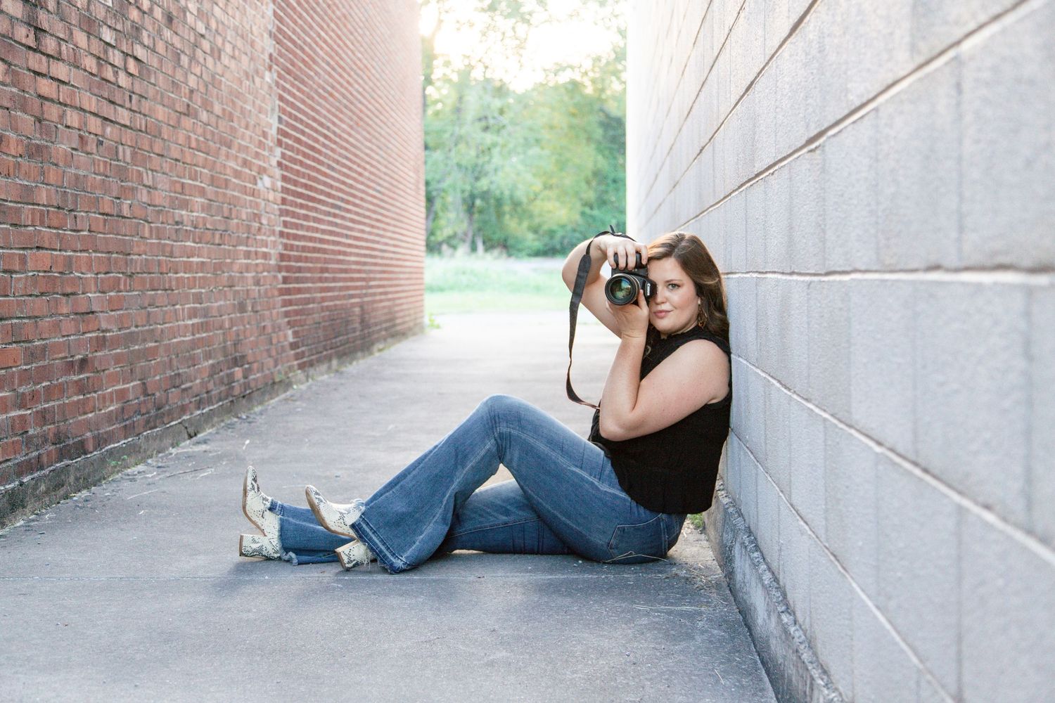 A person in casual attire leans against a brick wall in a series of artistic urban portraits.