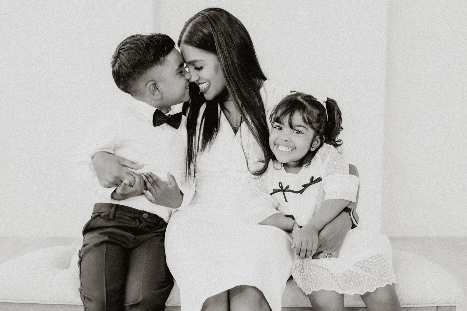 A series of black and white photos showing tender family moments and interactions between parents and children.