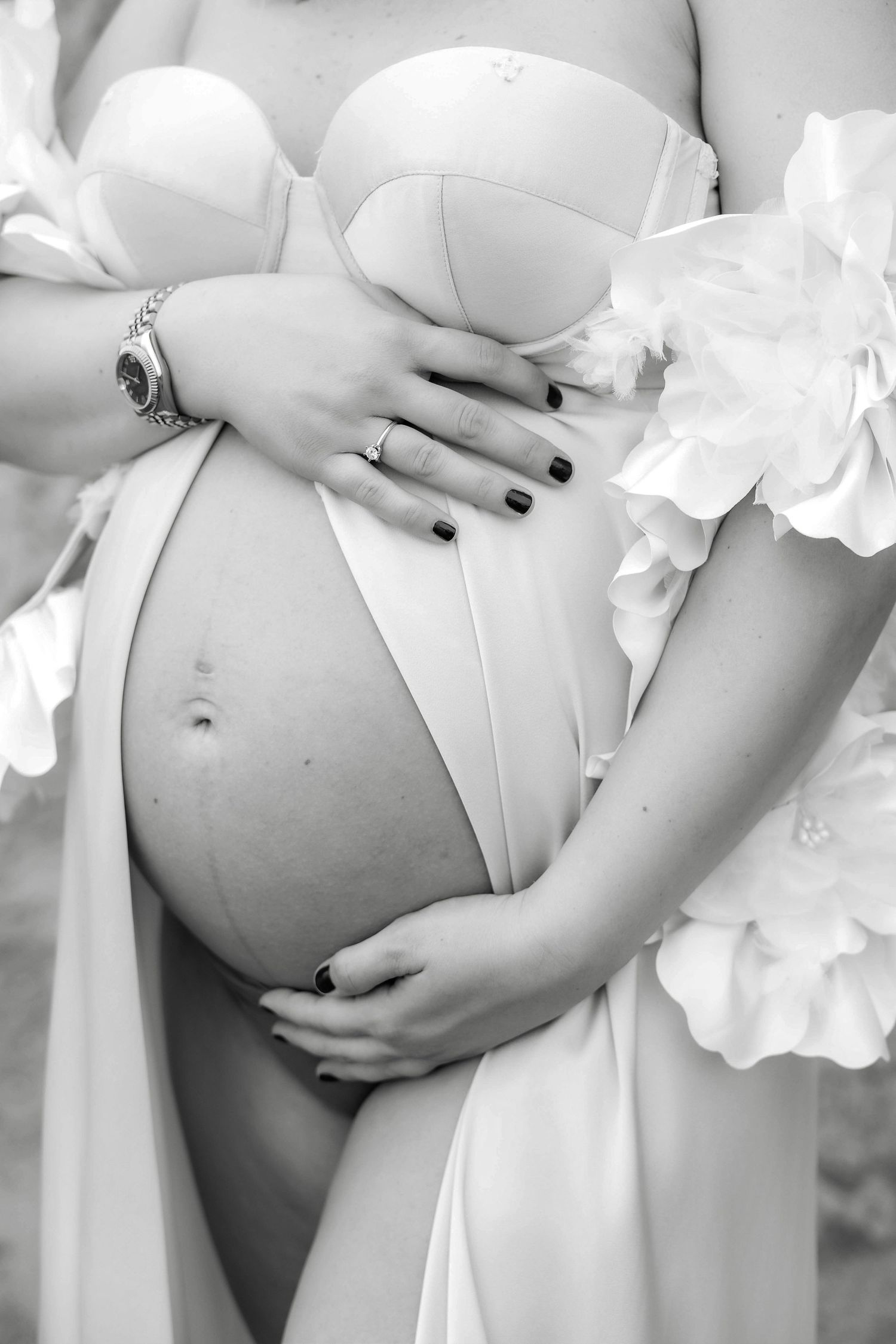 Black and white close-up maternity photos with white floral details.