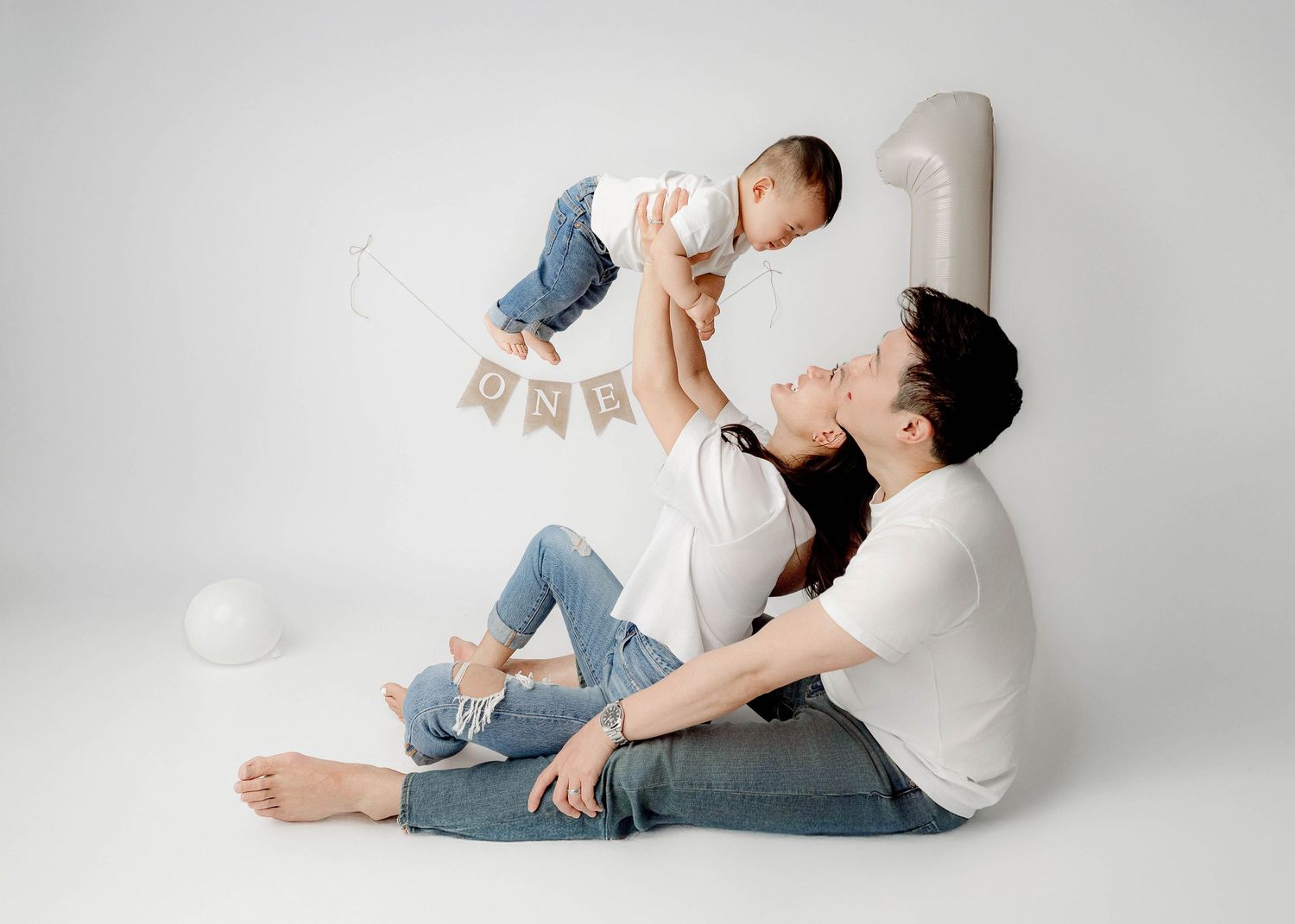 Playful lifestyle photos showing intimate family moments against a light gray studio background.