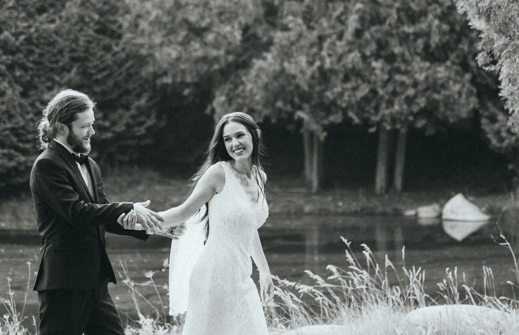 Black and white wedding portraits captured in sequence against a natural outdoor backdrop.