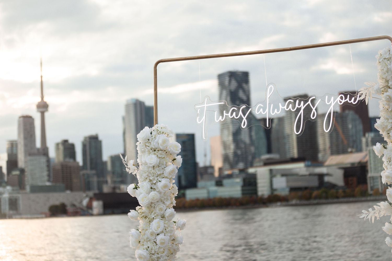 Urban skyline view with decorative white floral elements in the foreground.