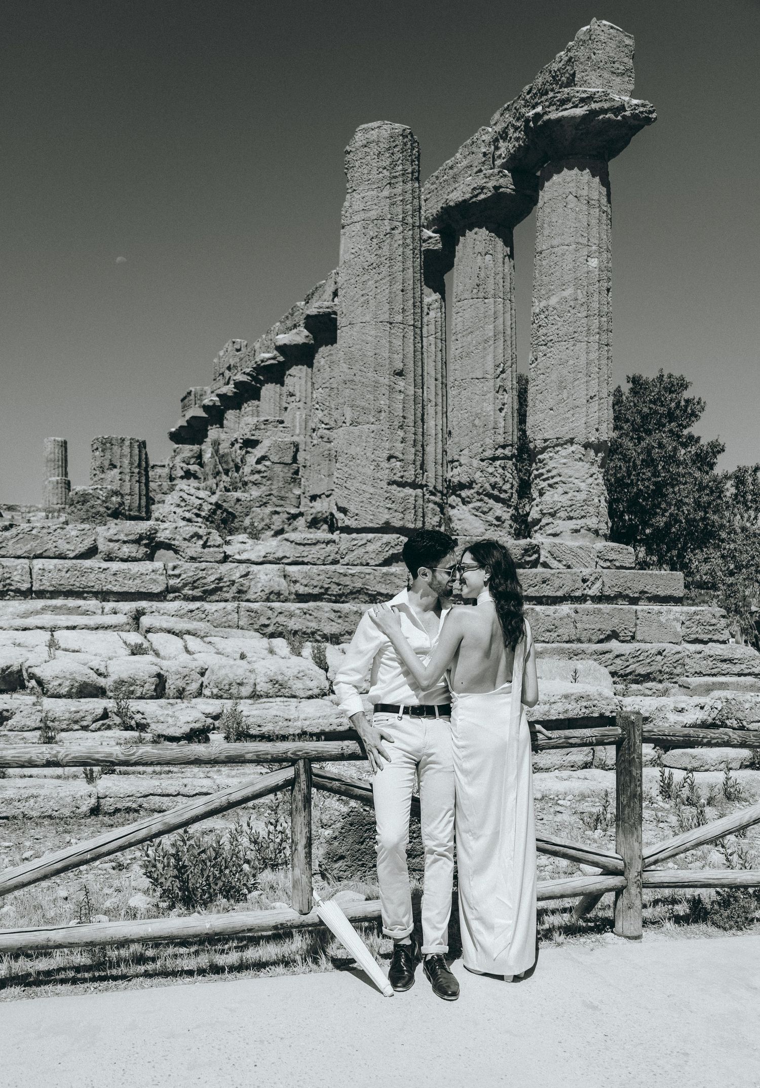 Vintage style photo of couple posing at ancient Greek temple archaeological site.