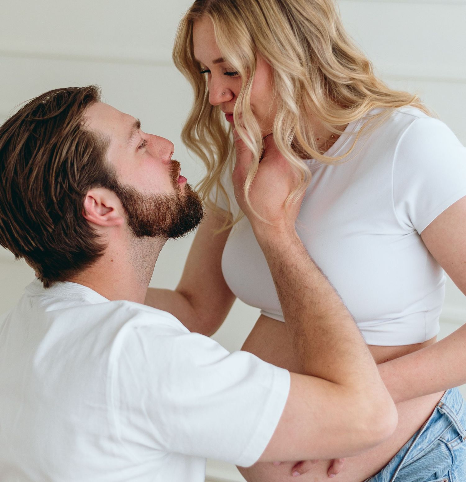 Series of romantic close-up shots showing tender moments between a couple in white shirts.