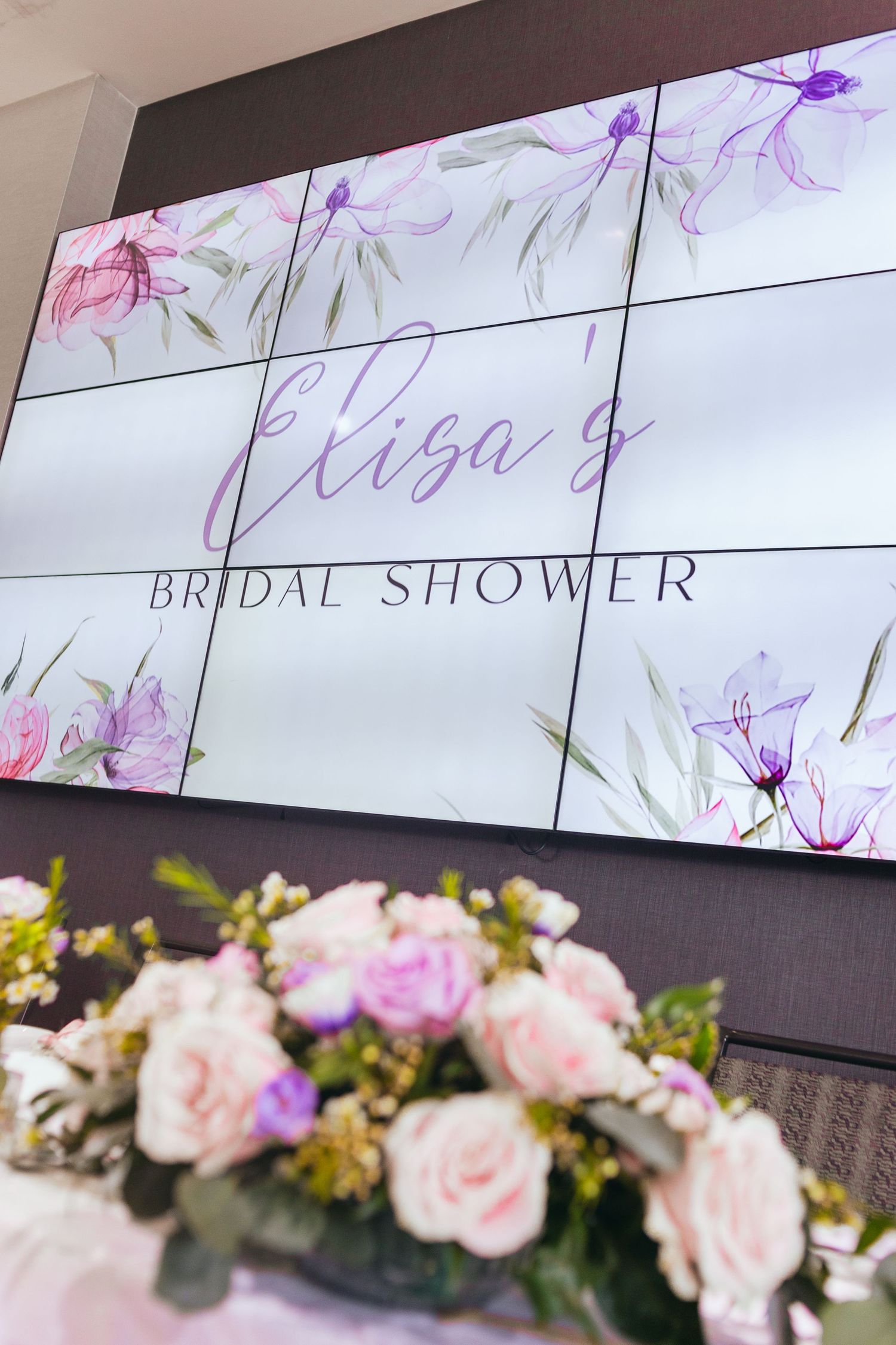 Delicate floral decorations and signage for a bridal shower event.