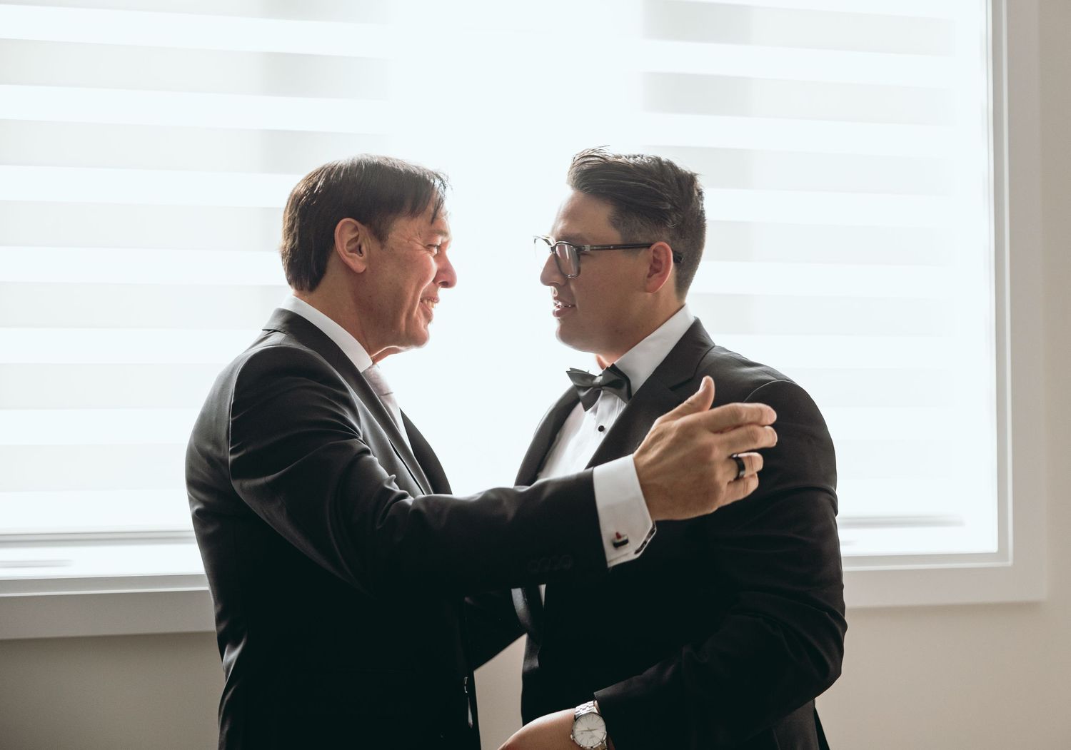 A sequence showing emotional interactions in formal wear by bright windows.