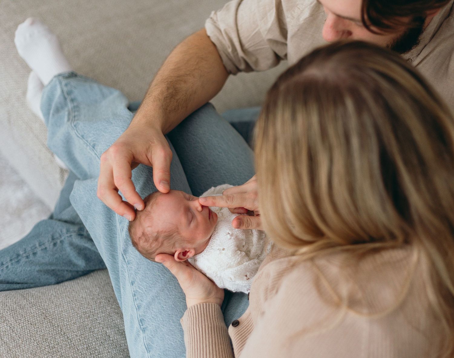 Family lifestyle session captured in muted tones with gentle interactions on a neutral background.