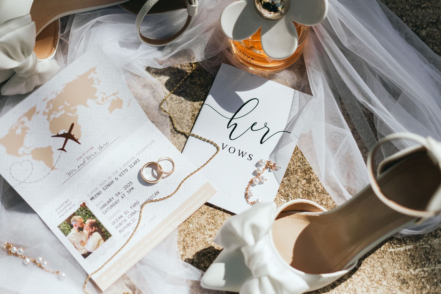 Wedding details and accessories arranged on textured surface with golden accents.