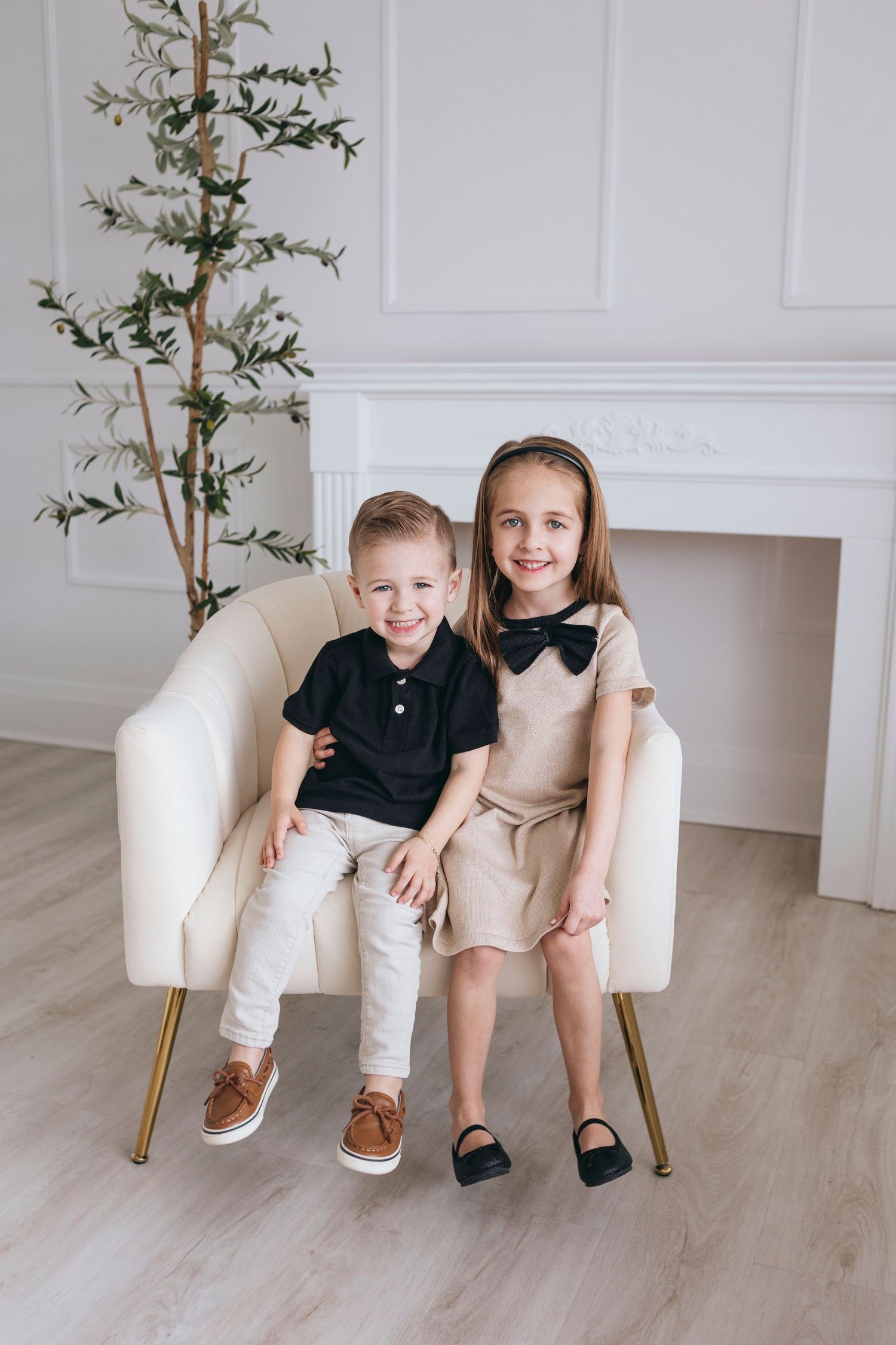 Studio portraits featuring modern white furniture and minimalist decor against white walls.