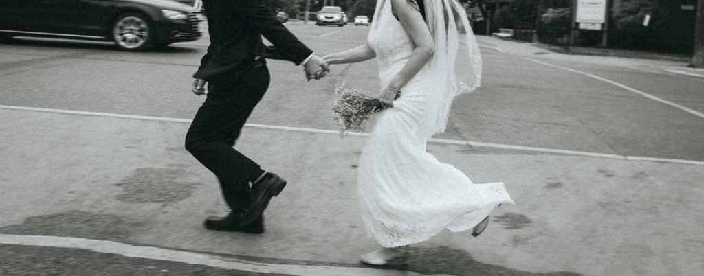 A wedding couple dances together in a series of black and white photos showing their graceful movements on the dance floor.