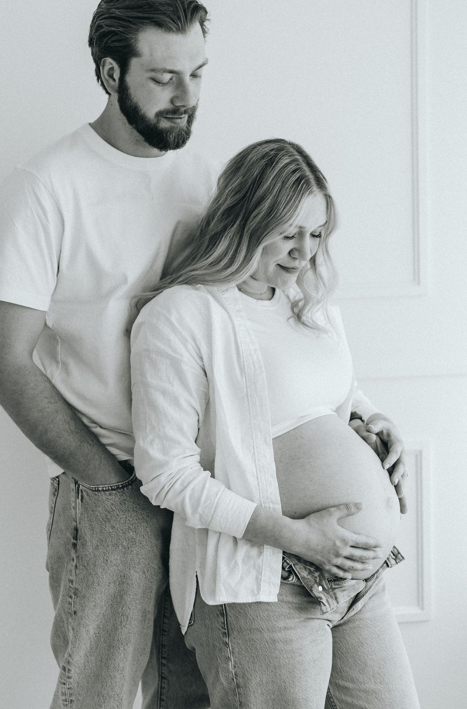 Romantic maternity session with couple in white and denim.