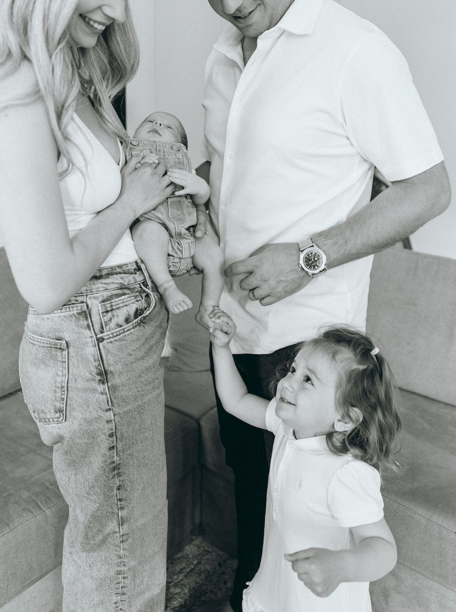 A casual family moment captured in black and white showing natural interactions.