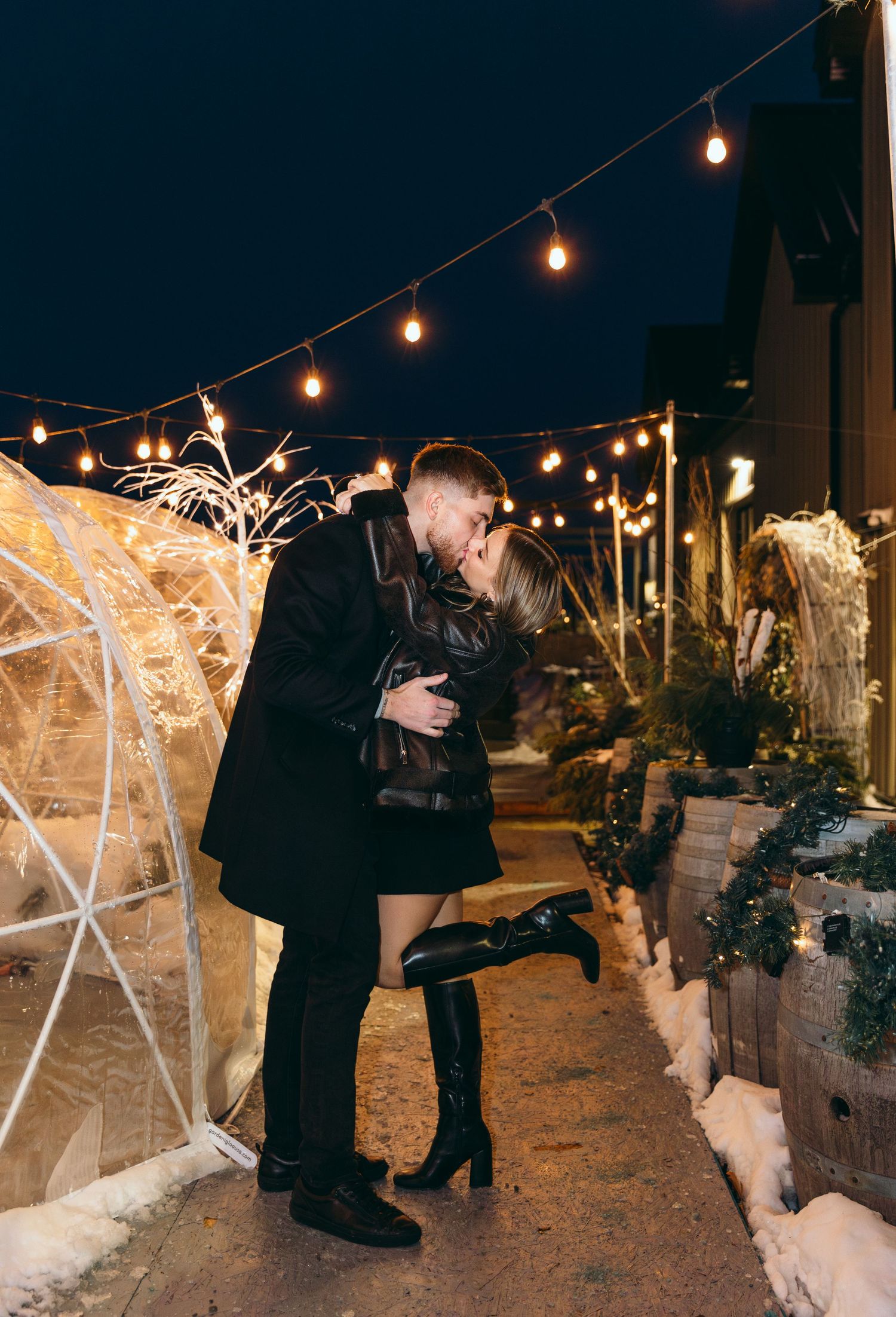 Celebration moment in winter setting with string lights and sparklers.