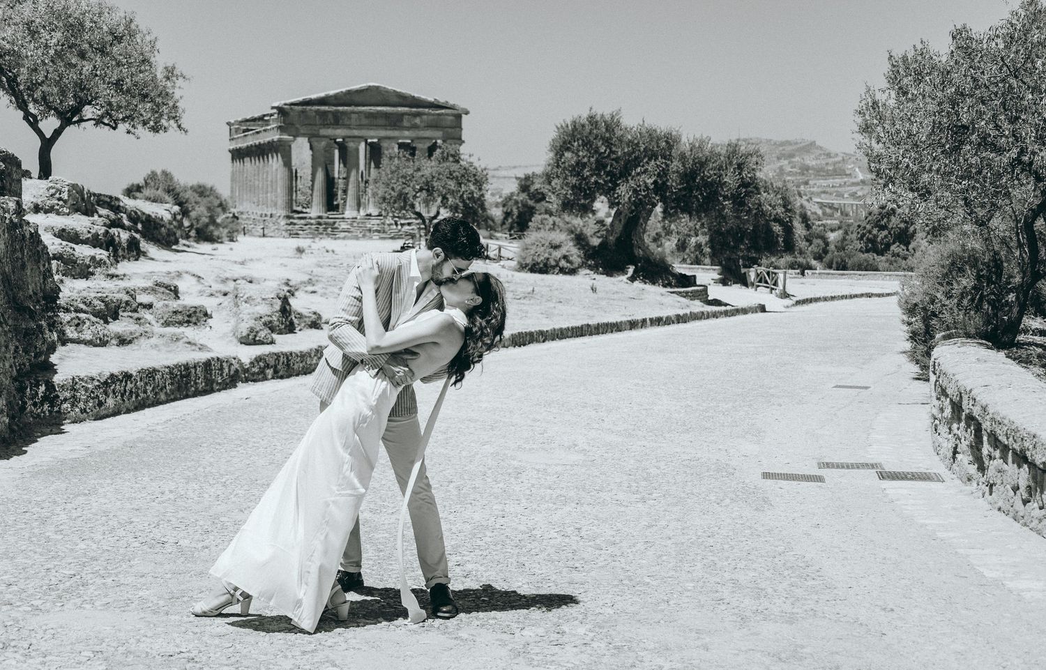 Ancient Greek temple ruins provide a stunning backdrop for a romantic photoshoot.