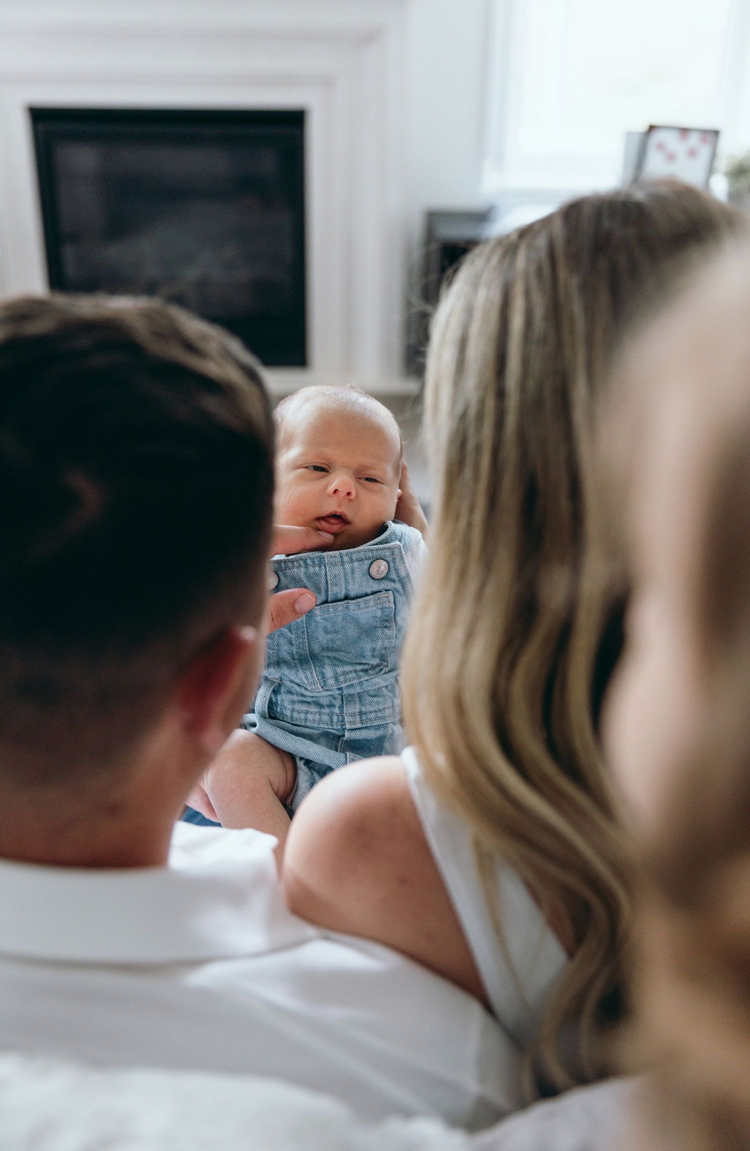 A candid family moment showing closeness and connection on a light background.
