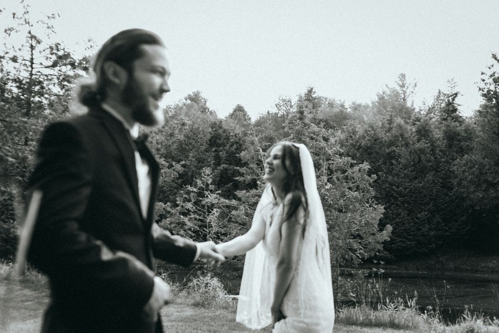 Wedding sequence showing playful interaction between couple in an outdoor setting.