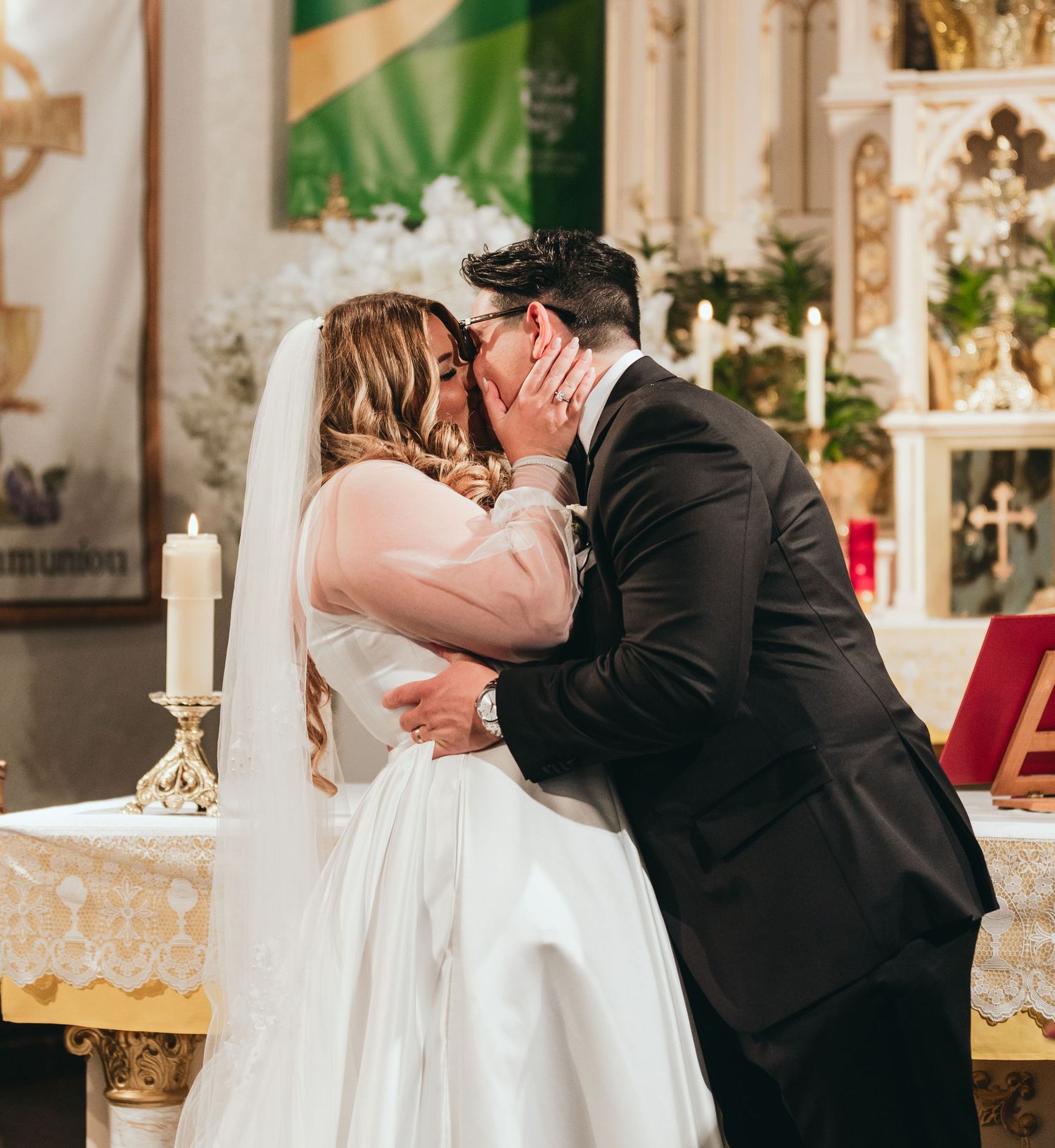Romantic wedding ceremony moment at ornate church altar.