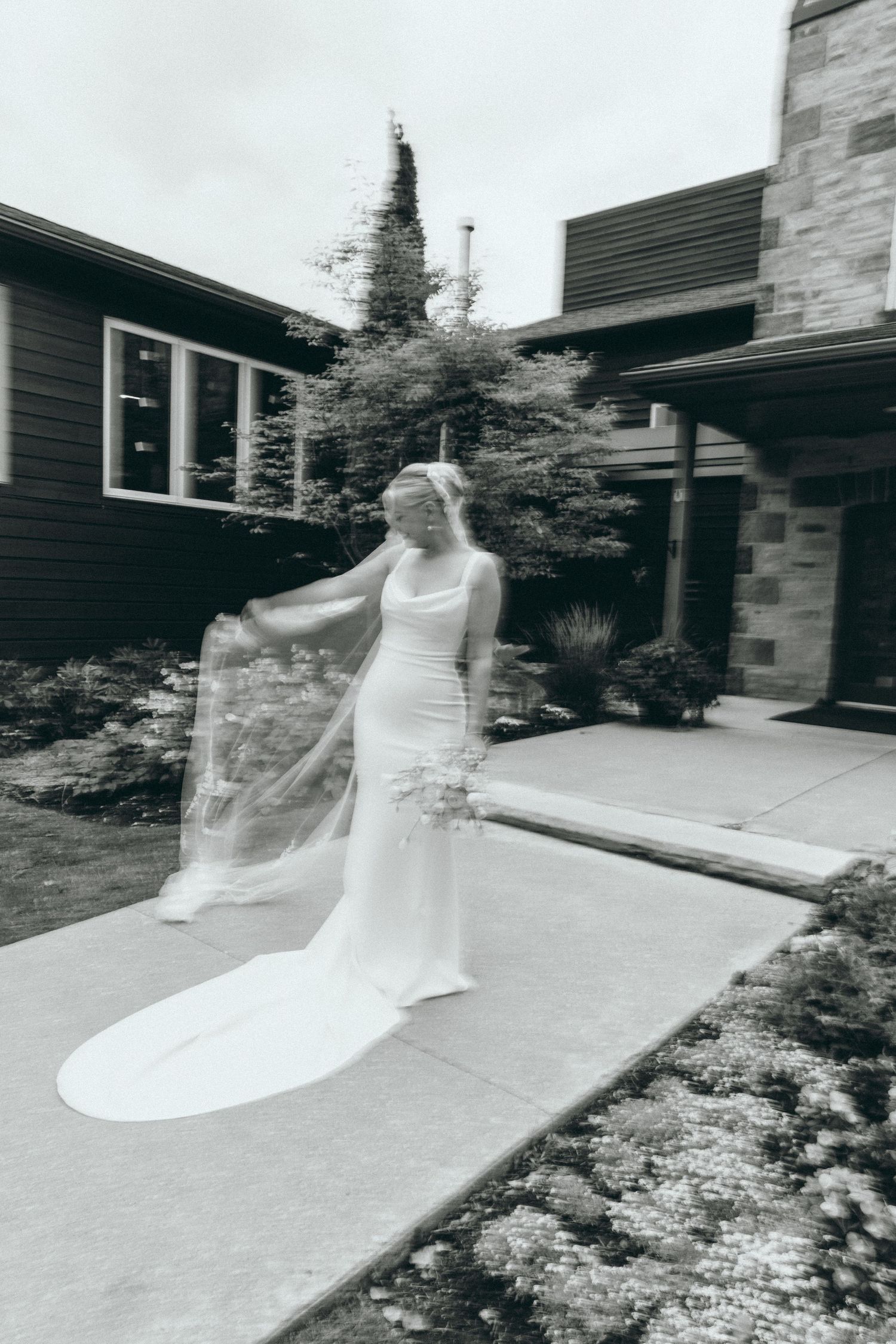 Motion-blurred photos of a flowing white wedding dress against modern architecture.
