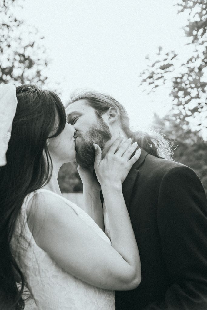Intimate black and white wedding portraits showing tender moments between newlyweds.