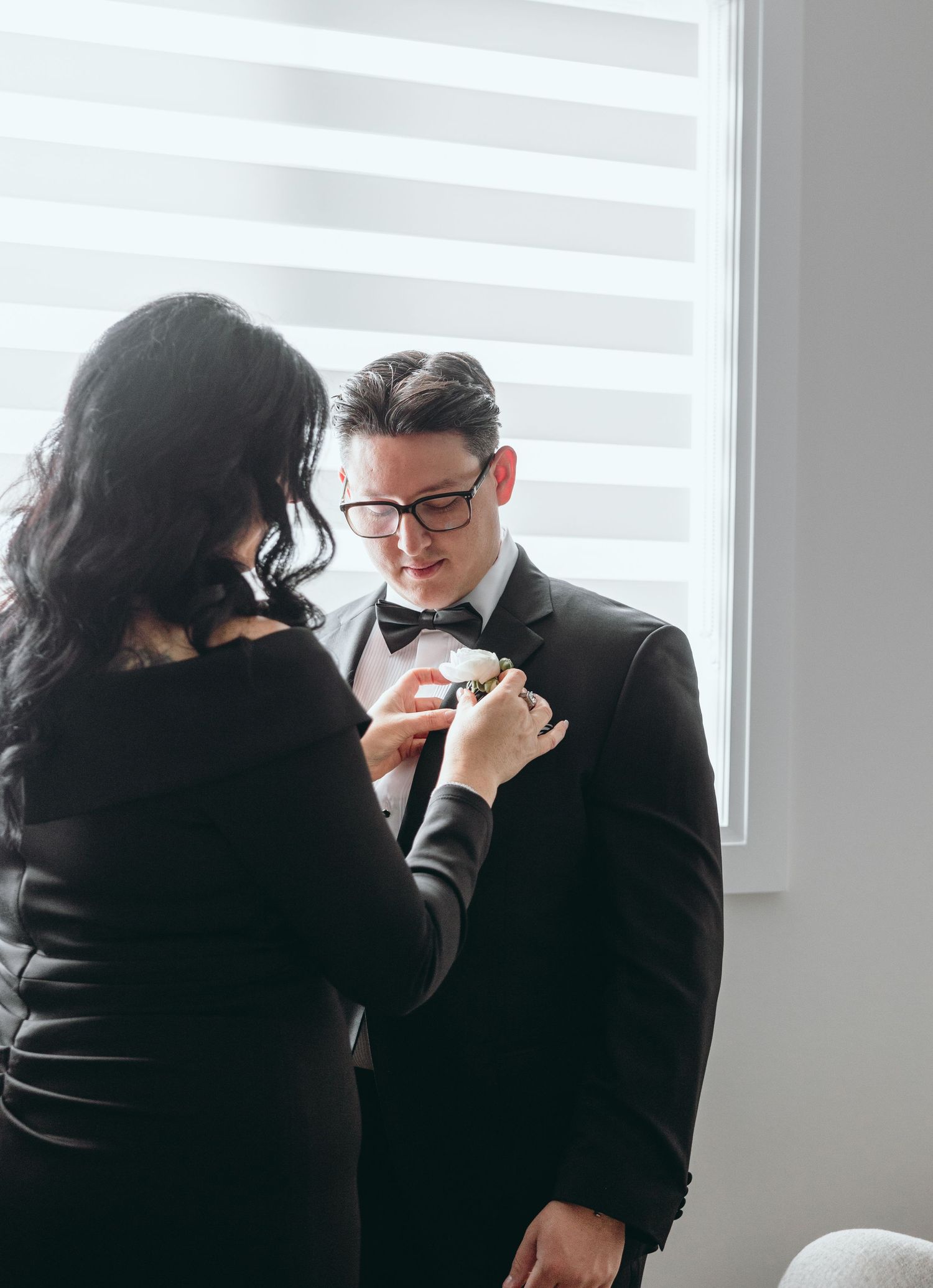 Candid moments captured in black and white showing preparation before a formal event.