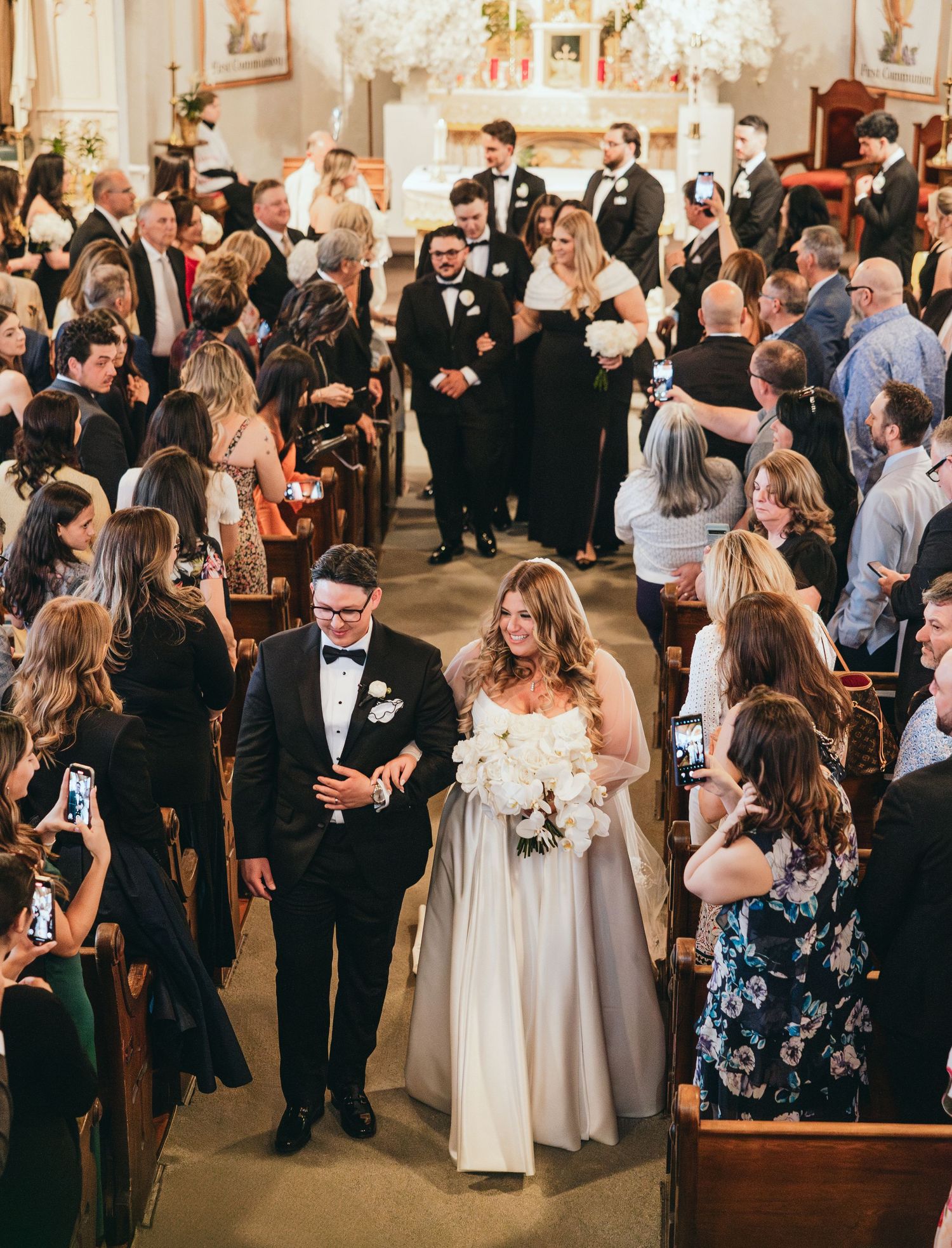 Guests mingle and celebrate at an elegant indoor wedding reception.