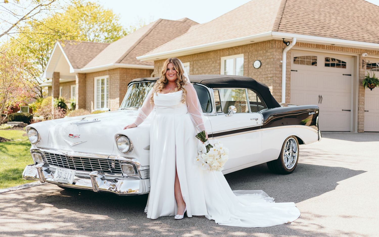 Classic white vintage car displayed at a wedding with elegant bridal details.