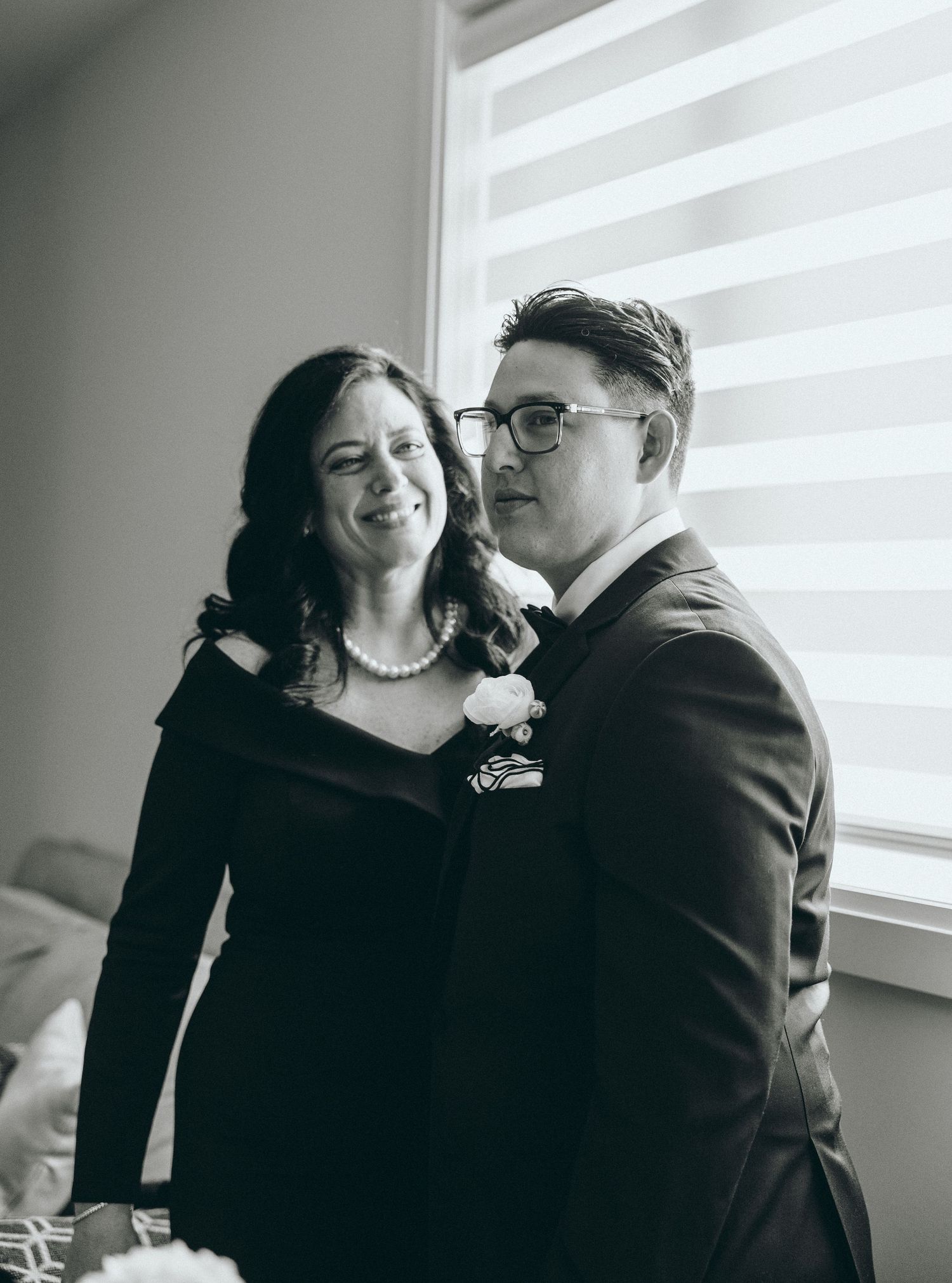 An intimate black and white portrait sequence capturing tender moments by a window.
