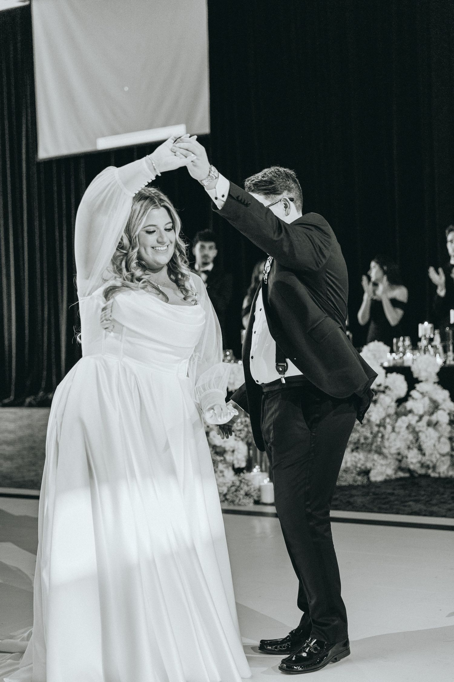 Wedding couple sharing their first dance in black and white photography.