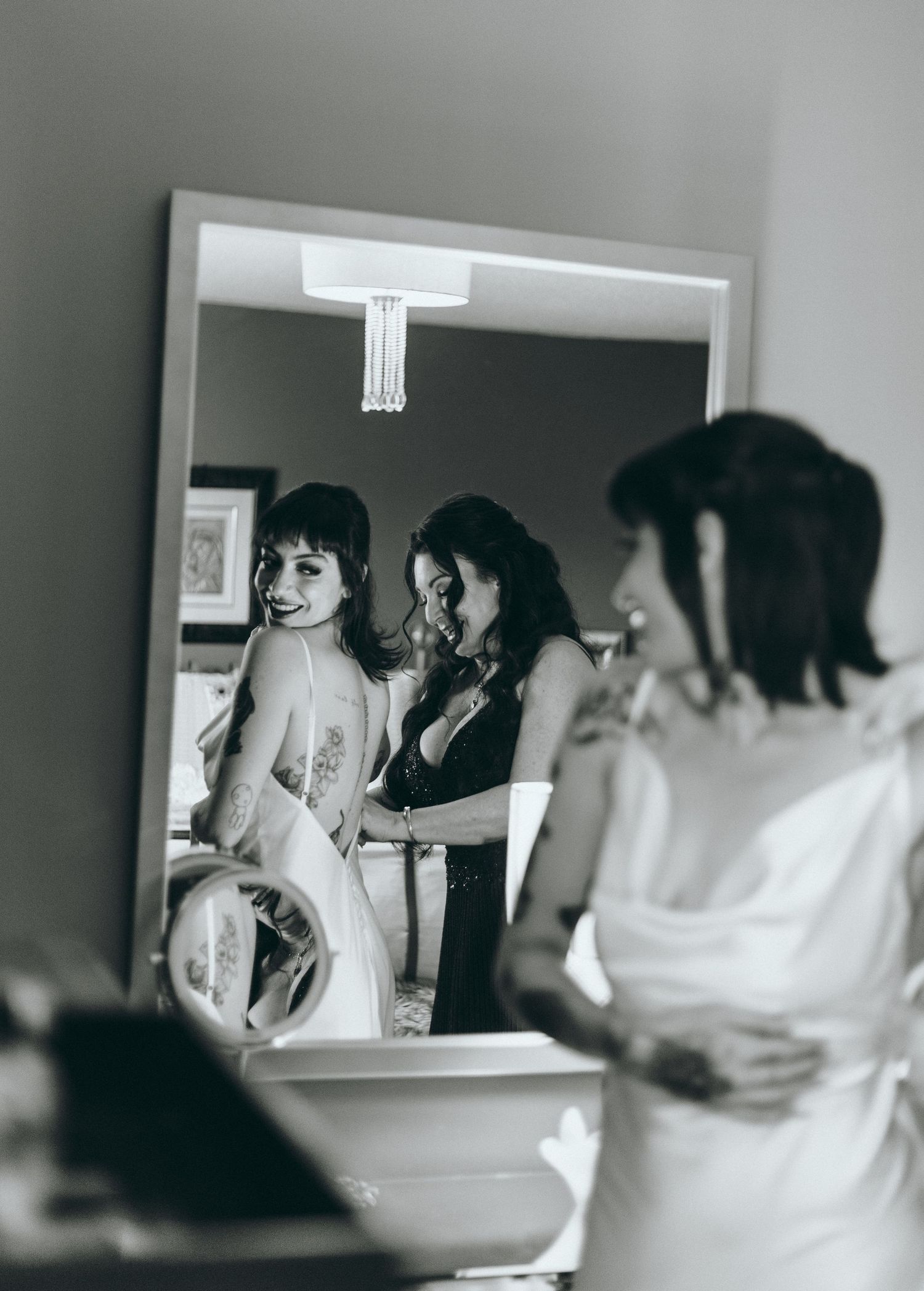 Black and white photo sequence showing wedding preparation moments in a bathroom.